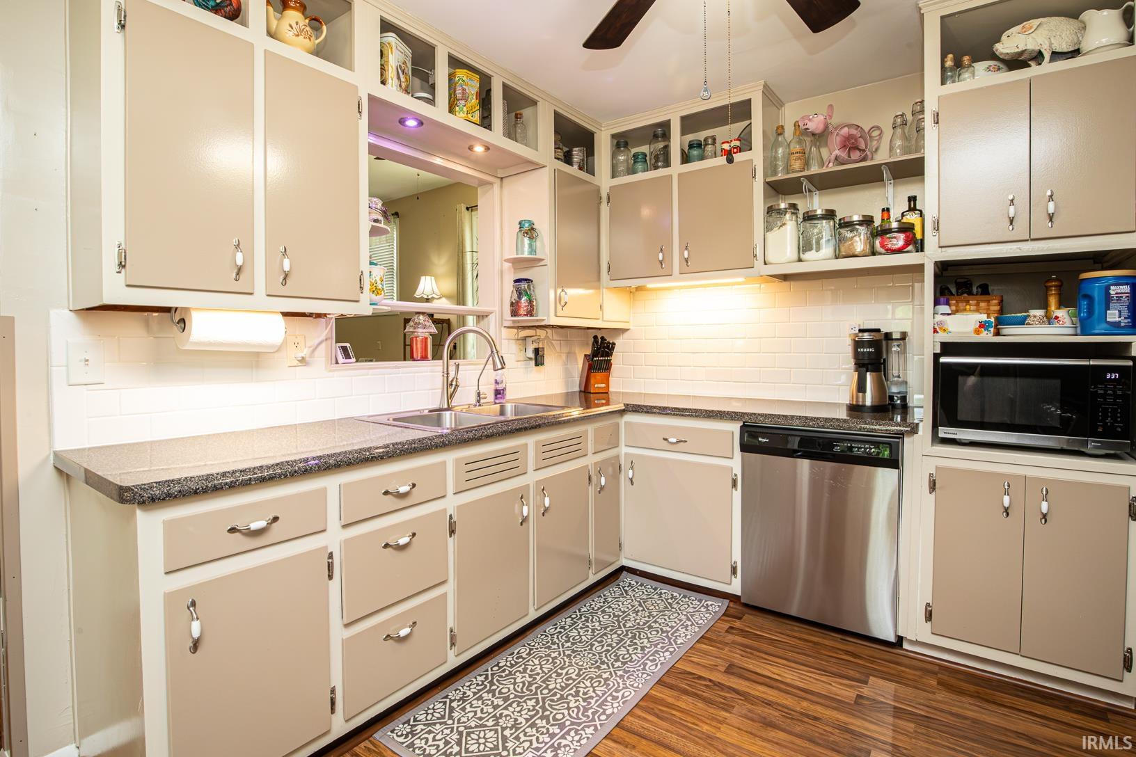 Kitchen featuring wood-finish flooring and a white subway tile backsplash