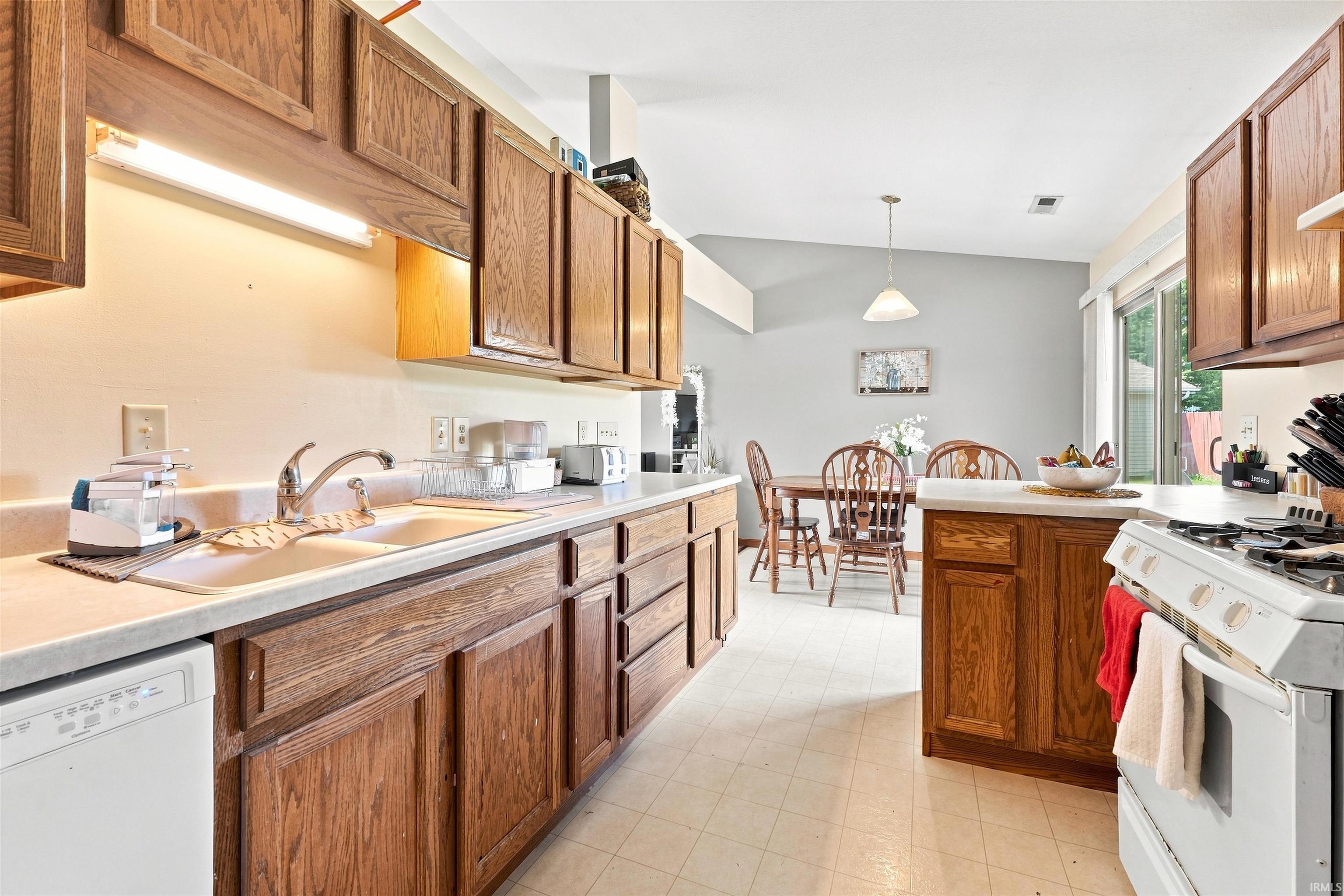 Kitchen with wood cabinetry and light countertops