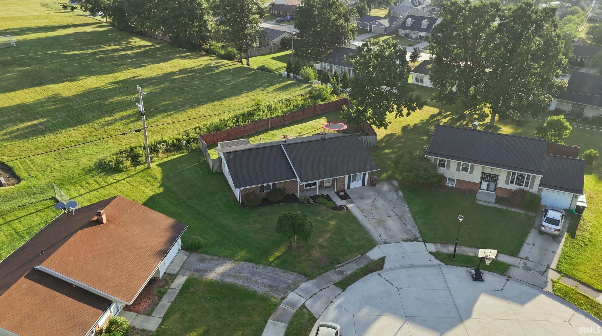 Single-story residence featuring a dark roof and light-colored siding