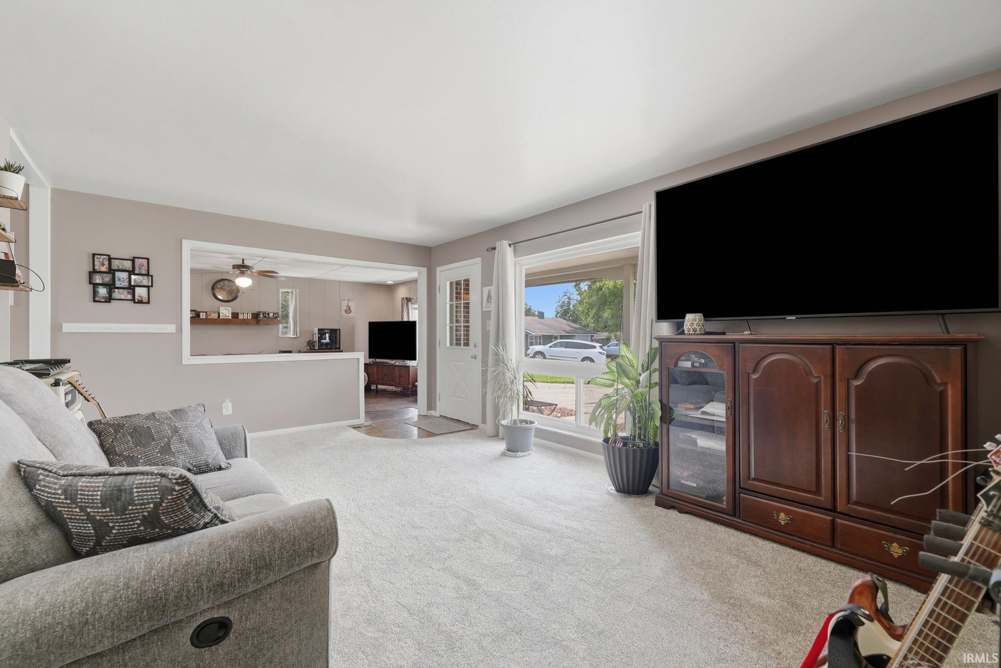 Light gray wall paint complemented by white trim and a neutral carpet