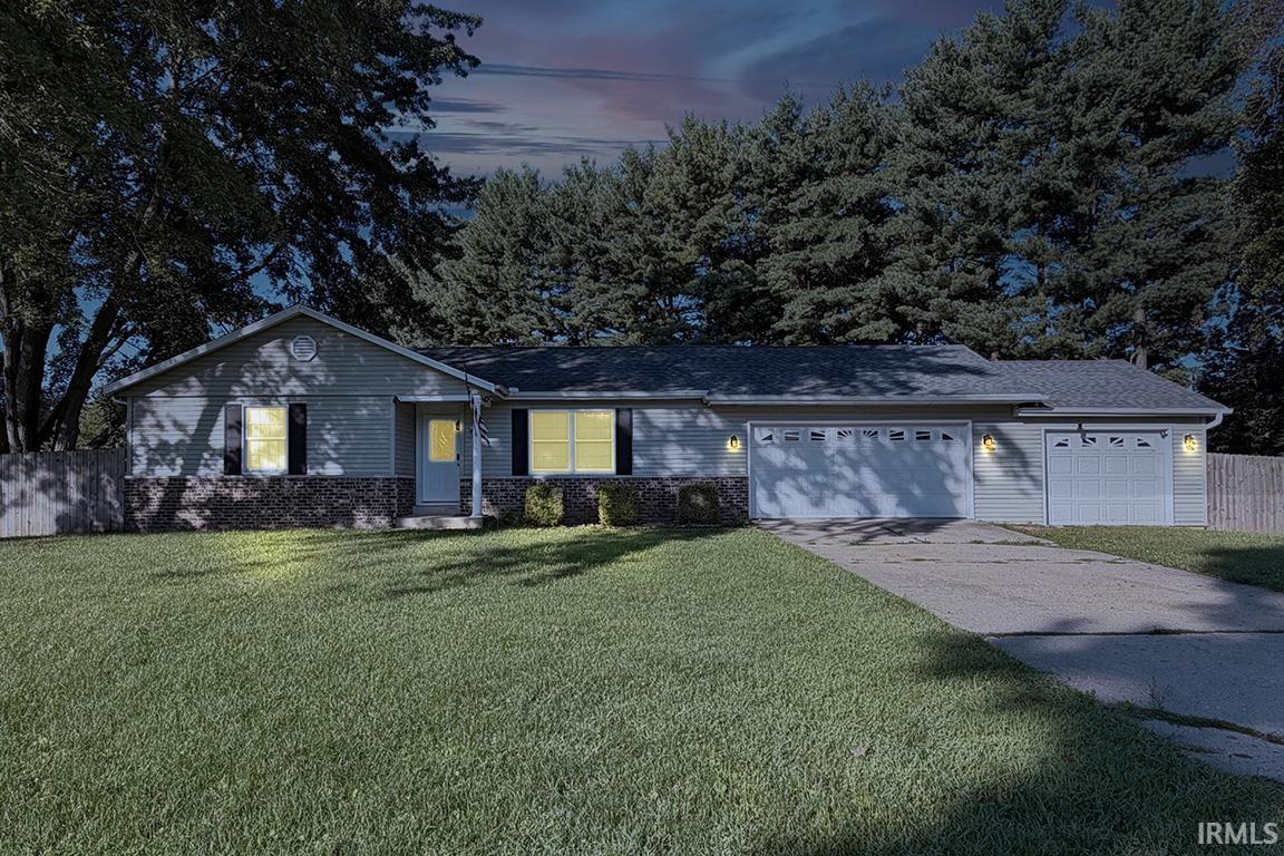 Ranch-style residence featuring light-colored siding and a stone facade