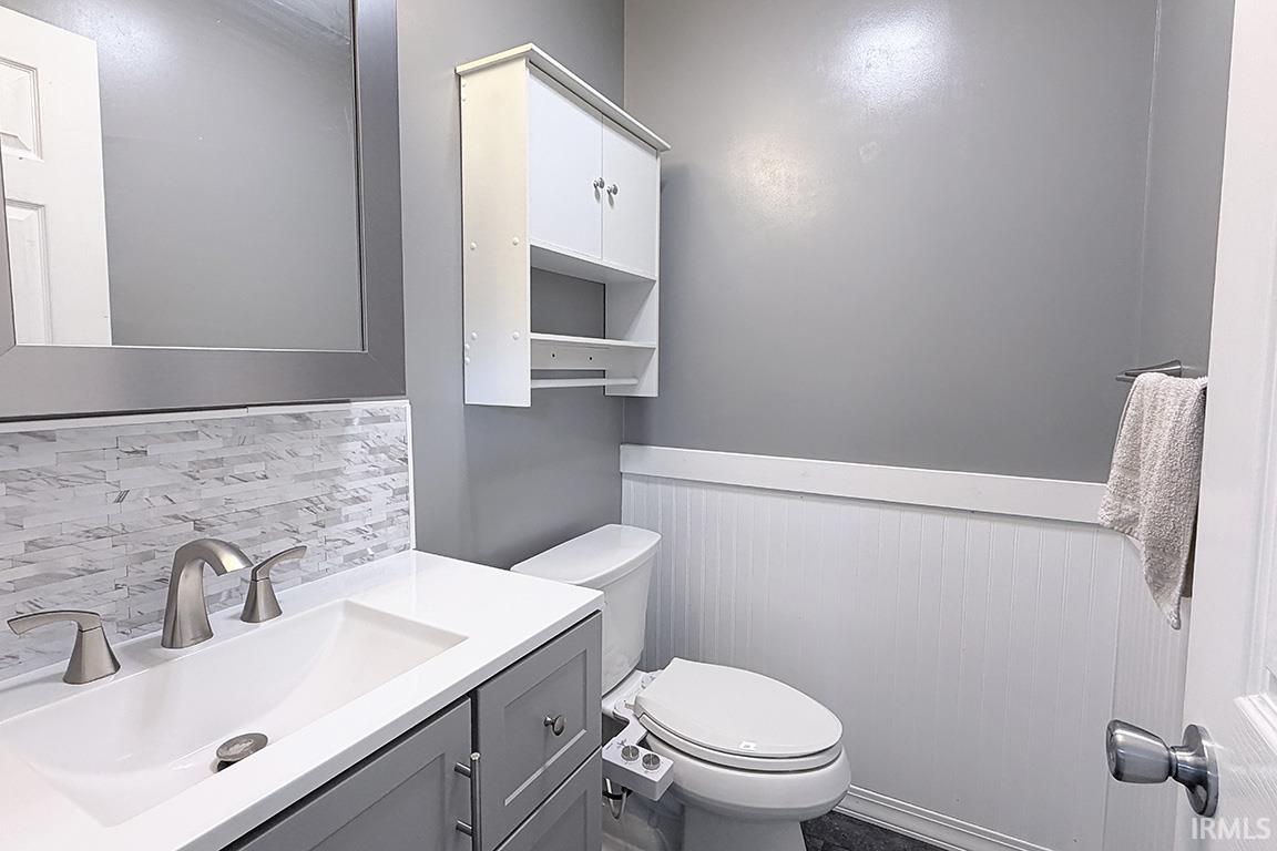 Modern vanity with an integrated sink, brushed nickel faucet, and a subway tile backsplash
