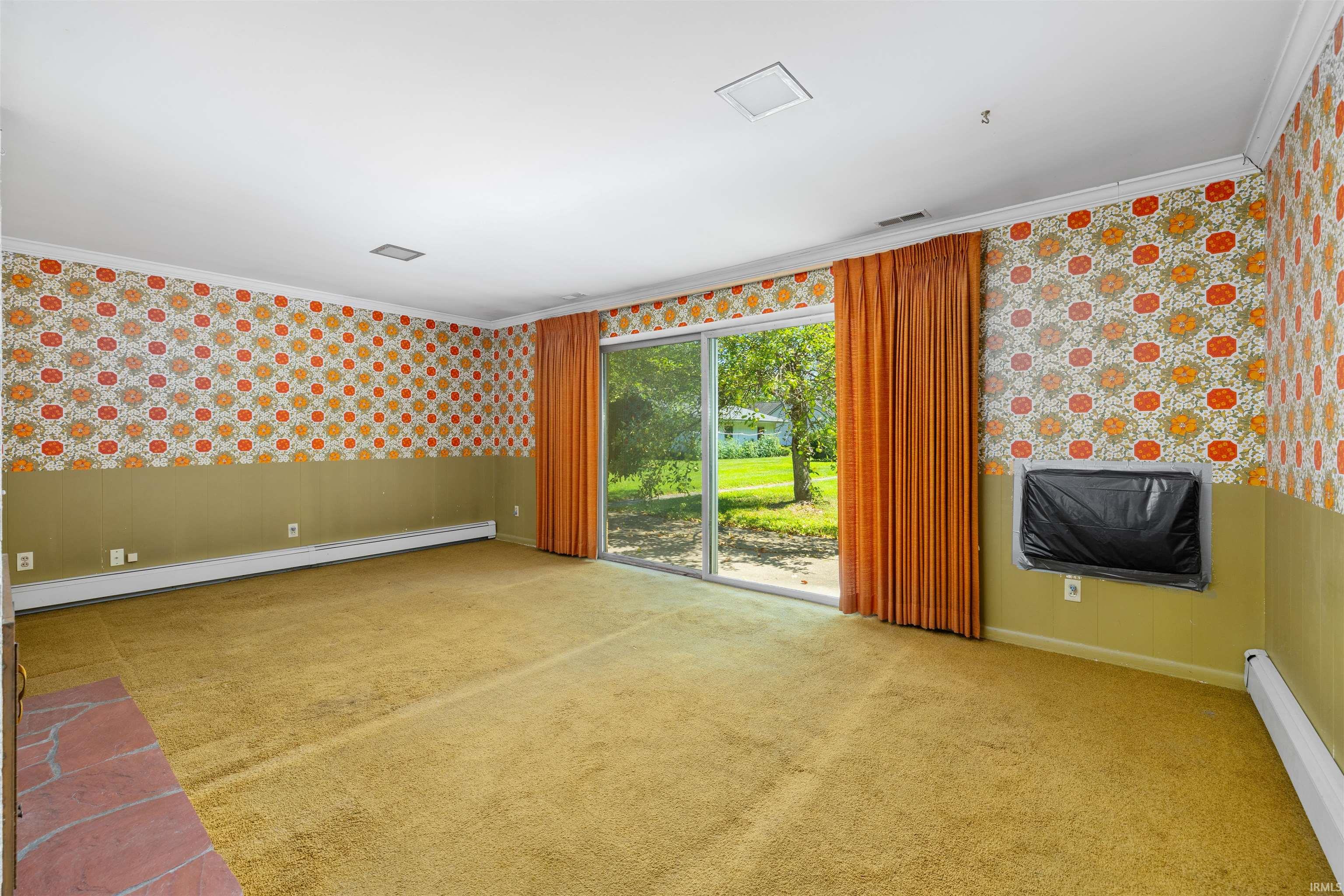 Carpeted room featuring a full wall of sliding glass doors