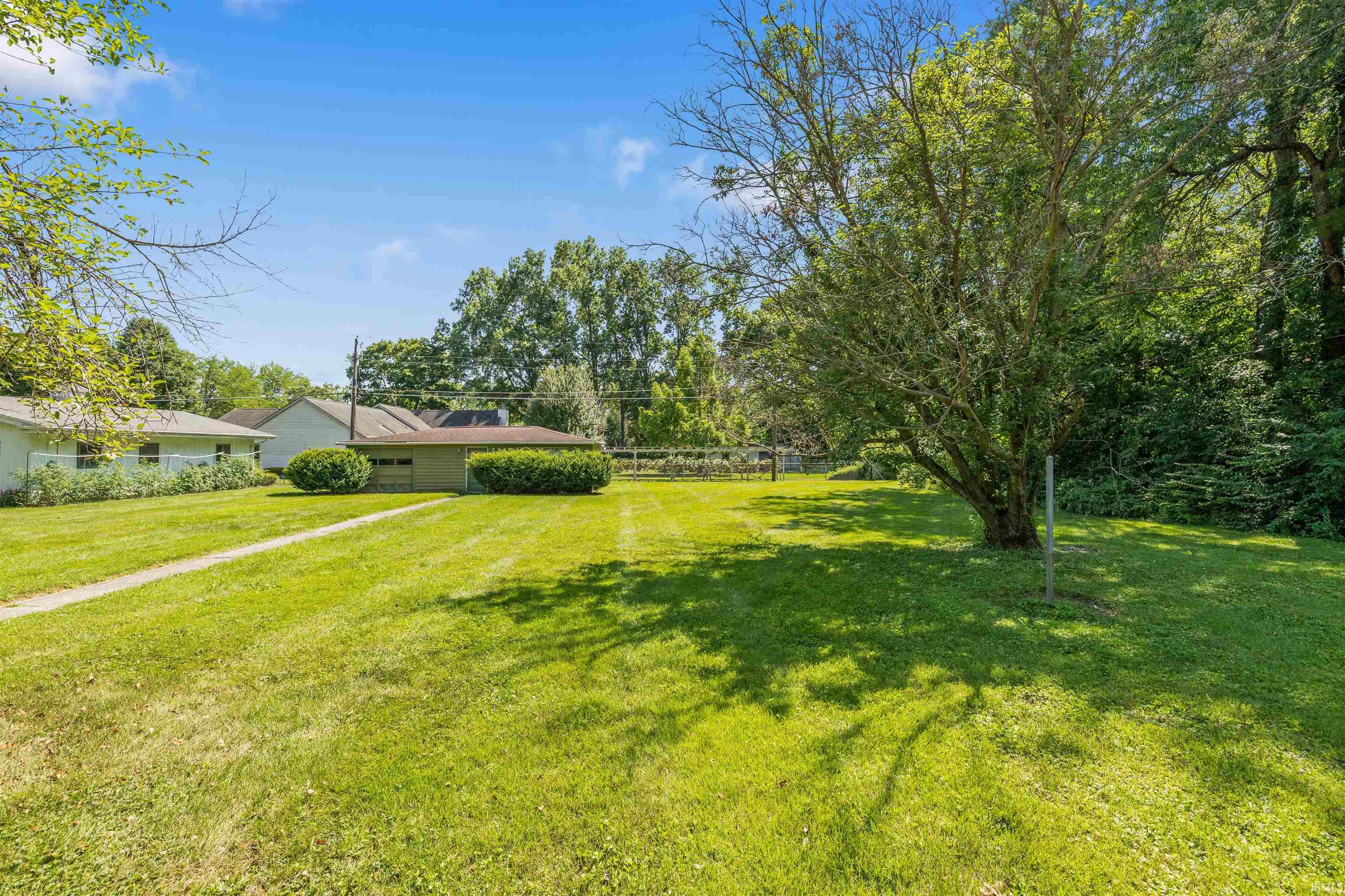 Expansive green lawn with mature shade trees