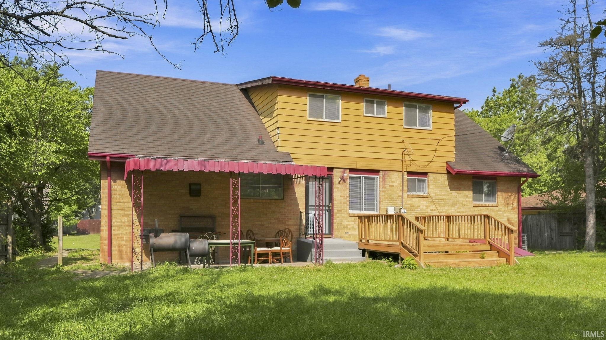 Brick and siding exterior featuring a multi-level structure