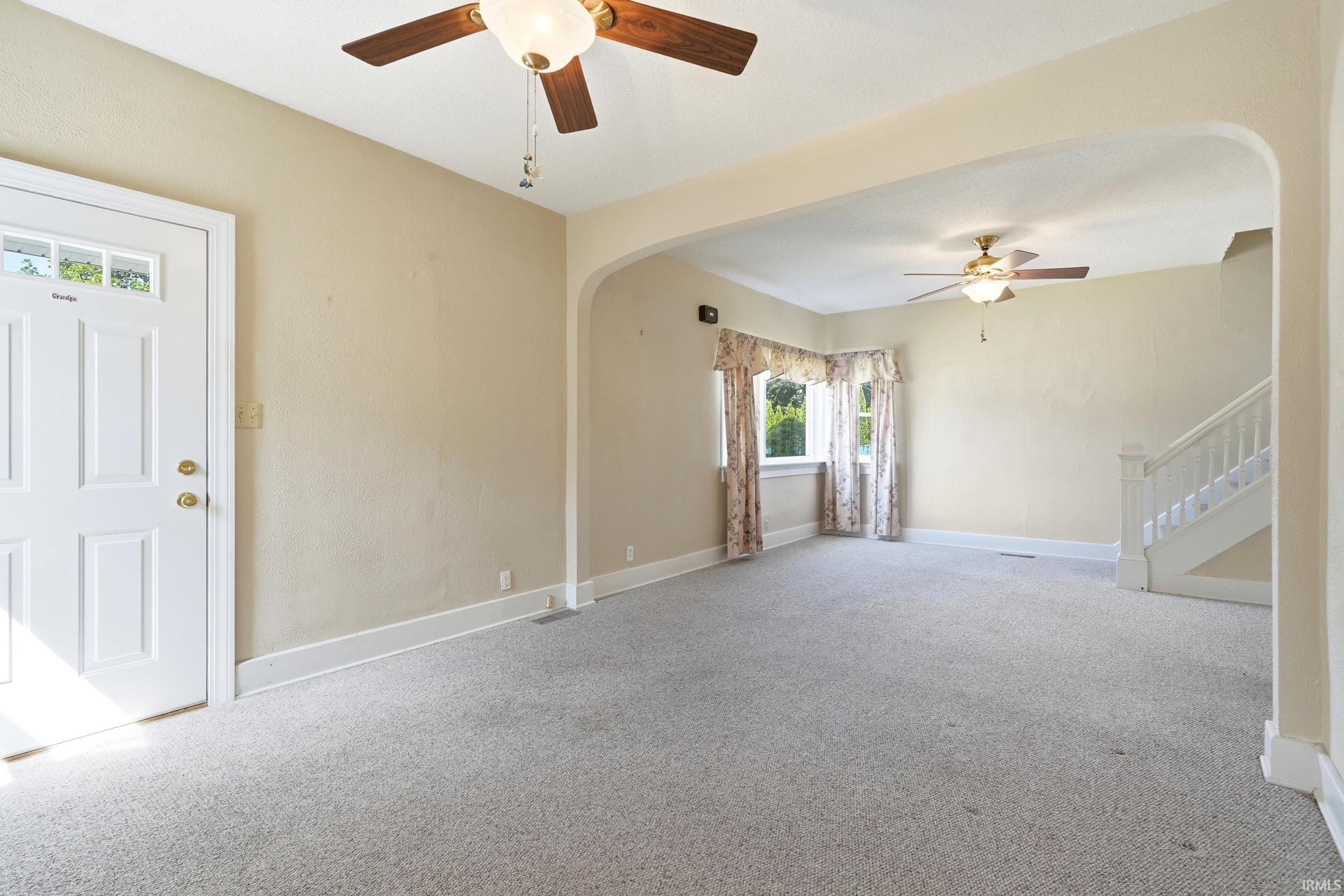 Bright interior space featuring light-colored walls and carpeted flooring