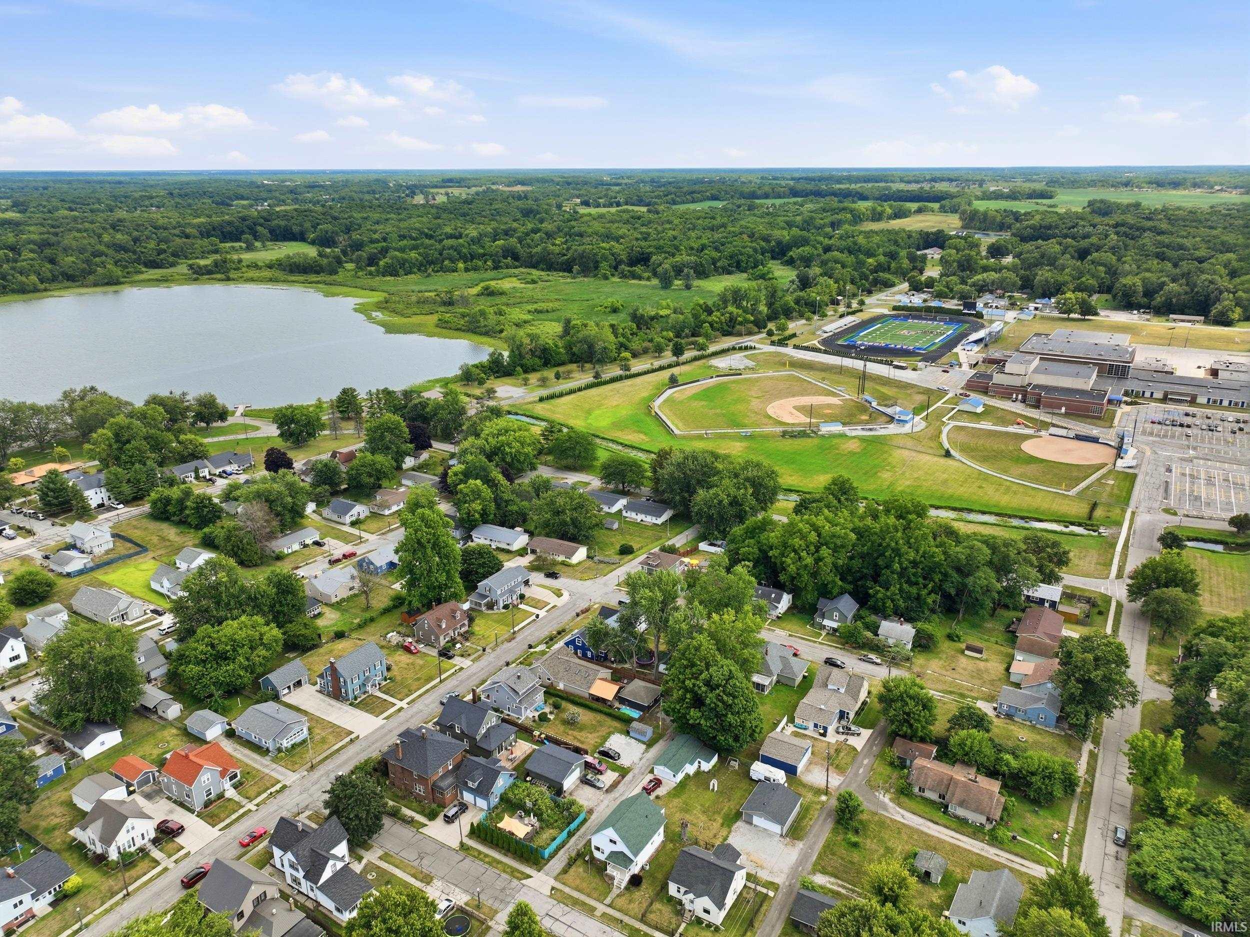 Aerial overview of a residential neighborhood with surrounding natural and recreational amenities