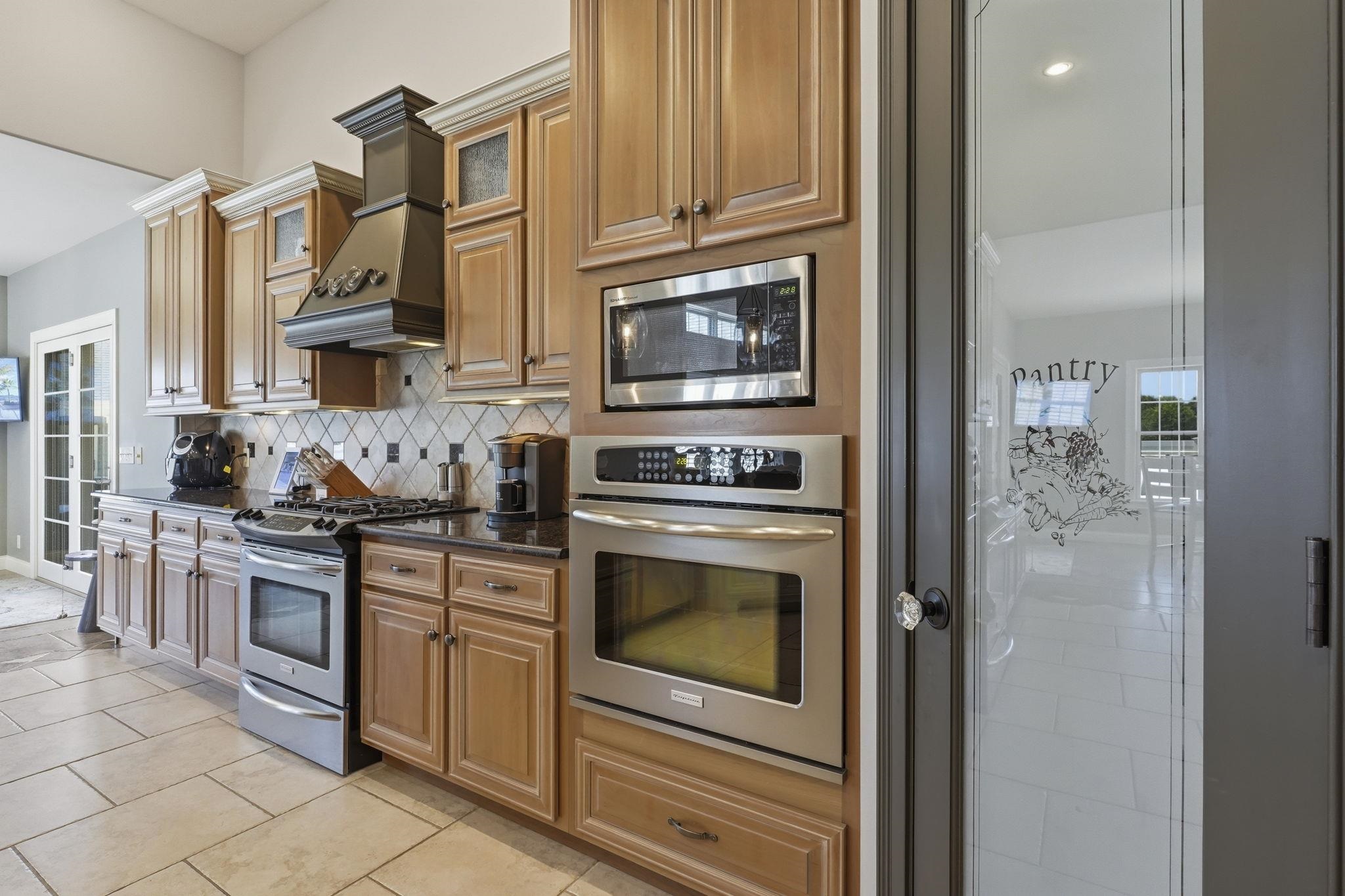 double ovens and a large corner pantry