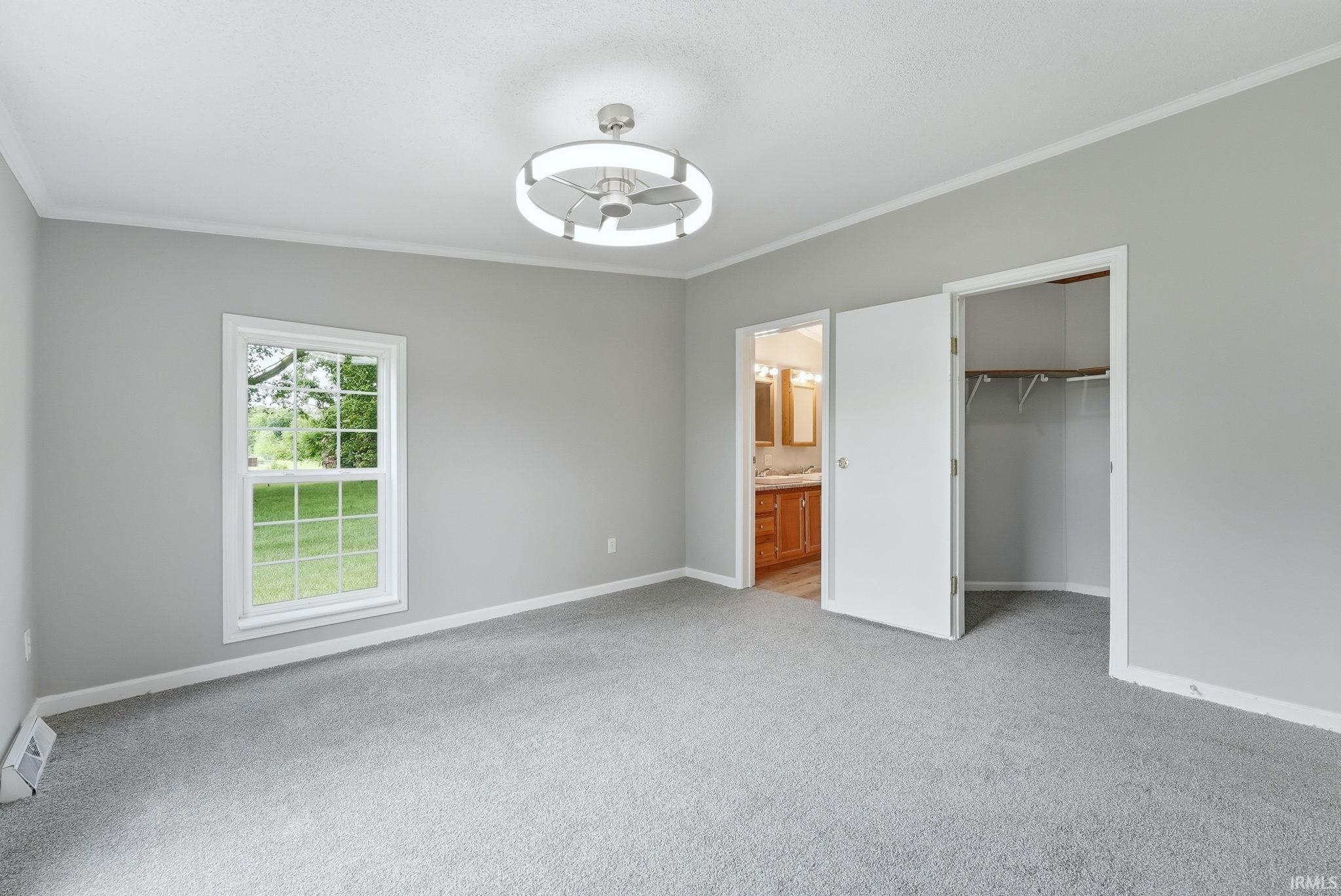 Bedroom featuring gray carpet flooring, light gray wall paint, and white trim