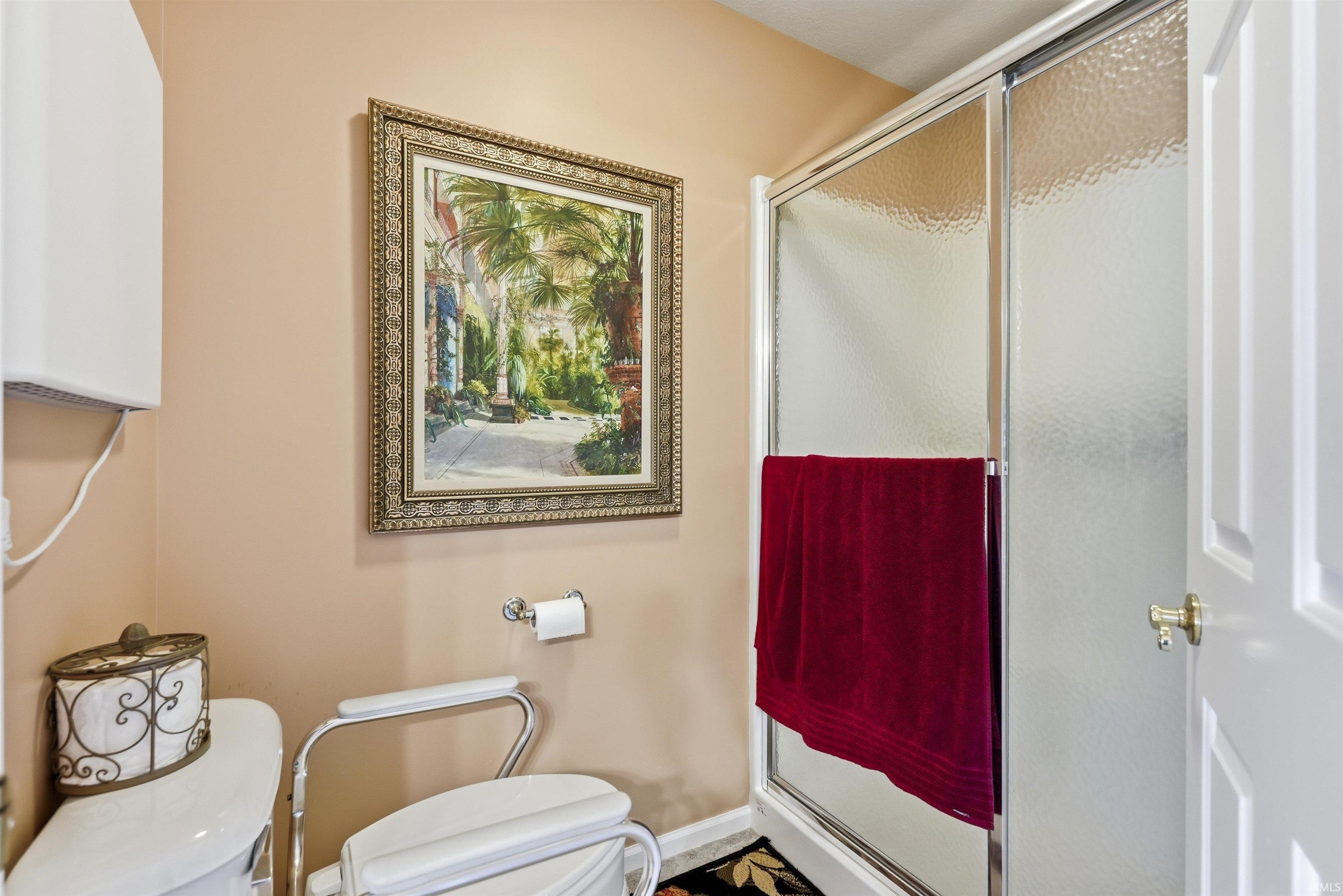 Walk-in shower featuring textured glass doors and a chrome frame