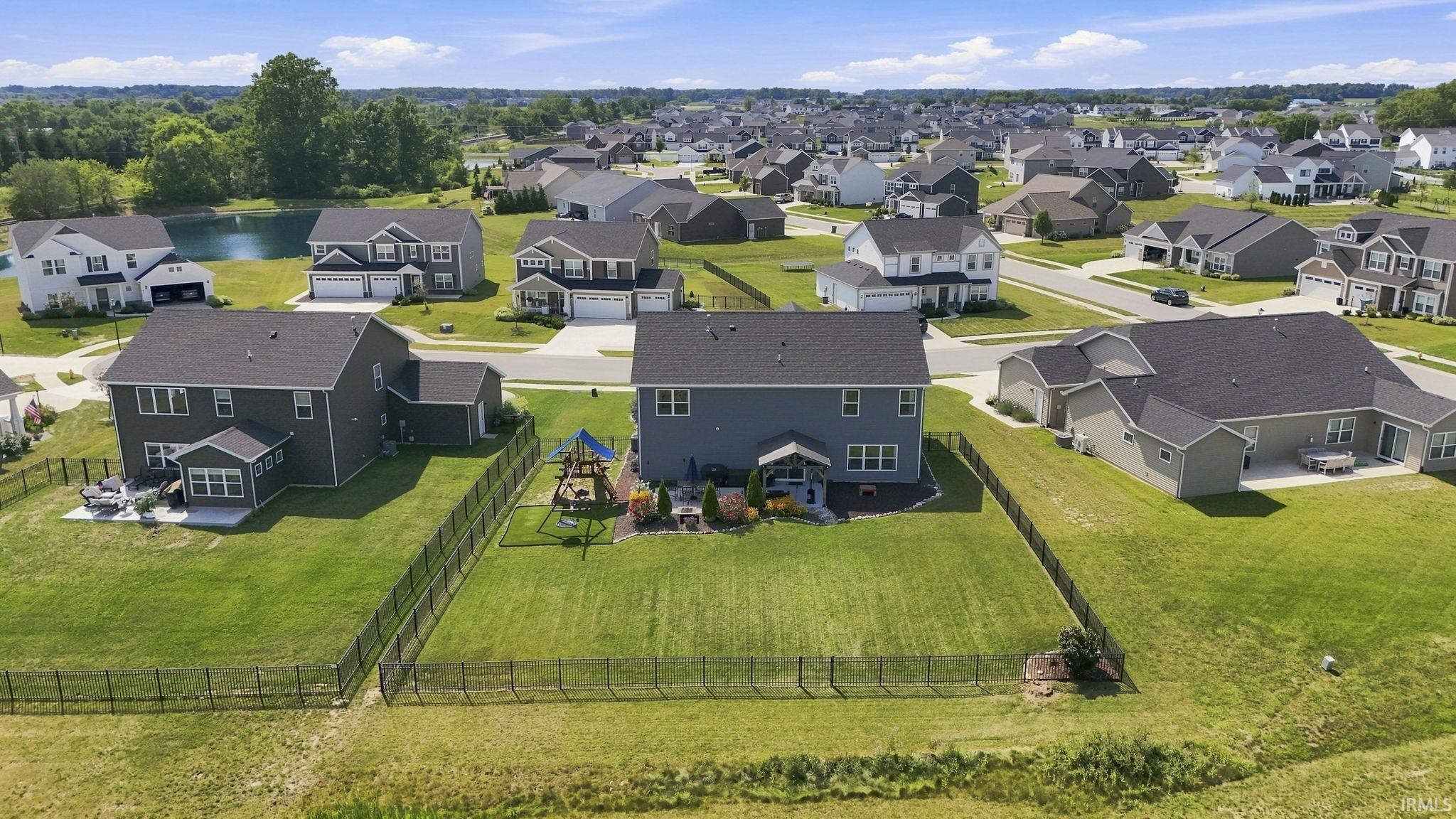 Expansive fenced backyard with a patio