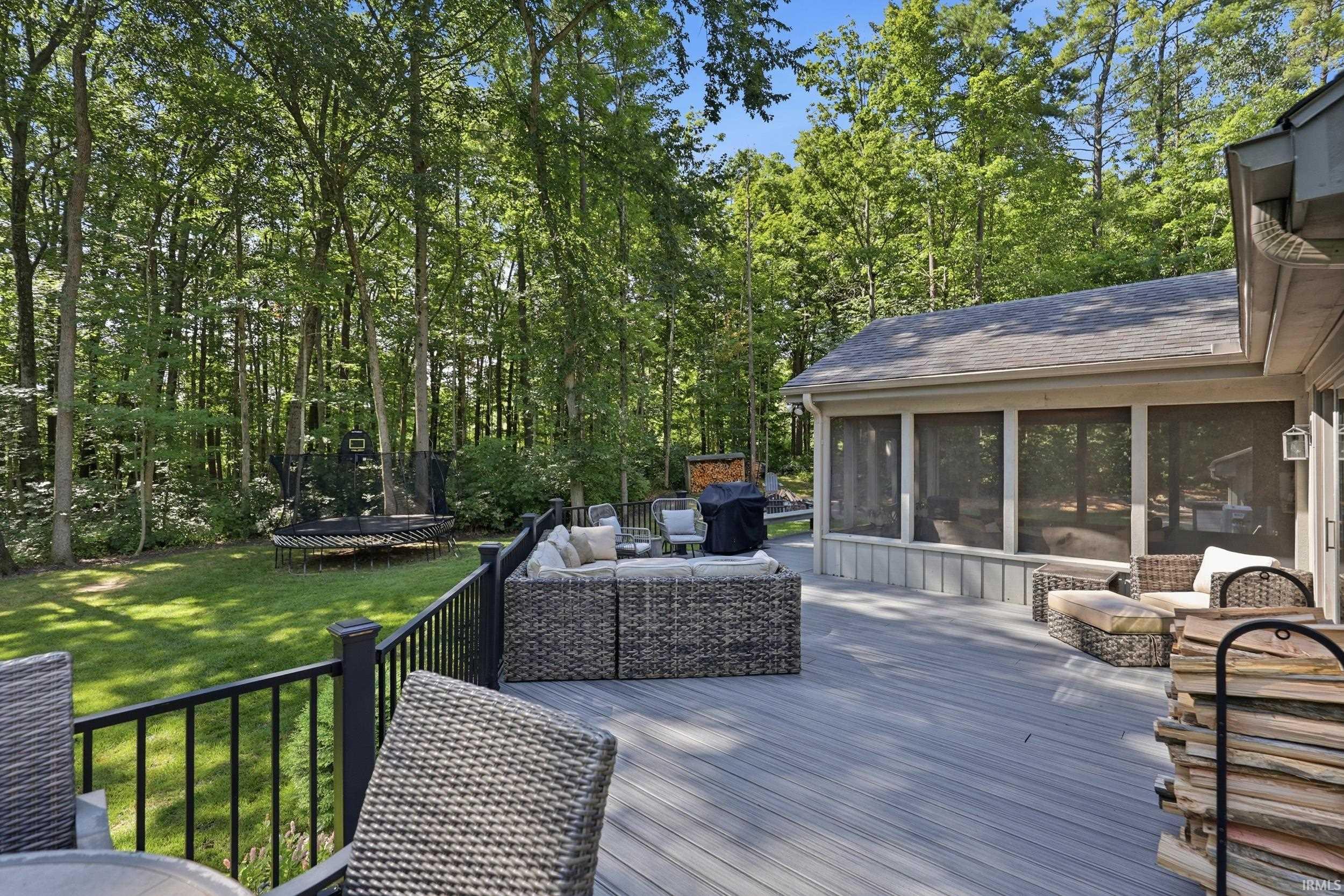 Spacious exterior deck featuring composite decking and black metal railings