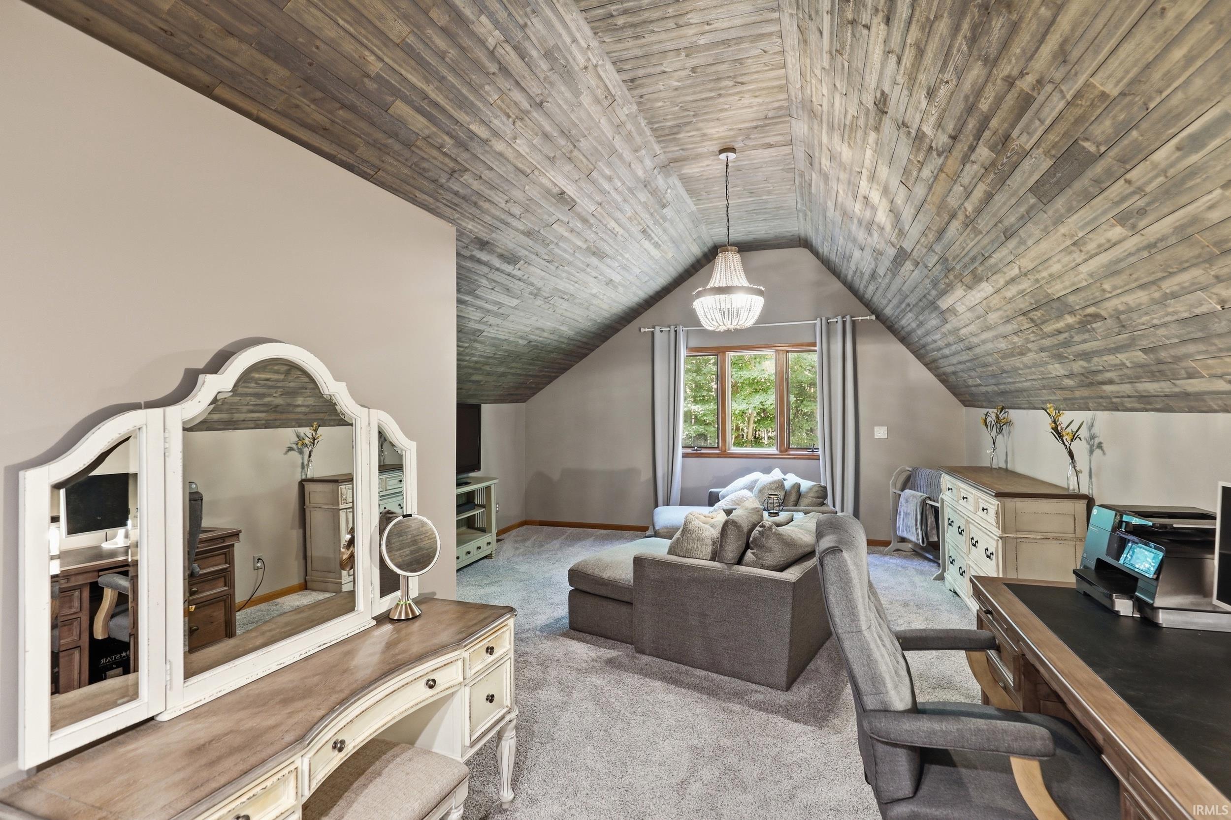 Vaulted wood-finish ceiling with chandelier lighting
