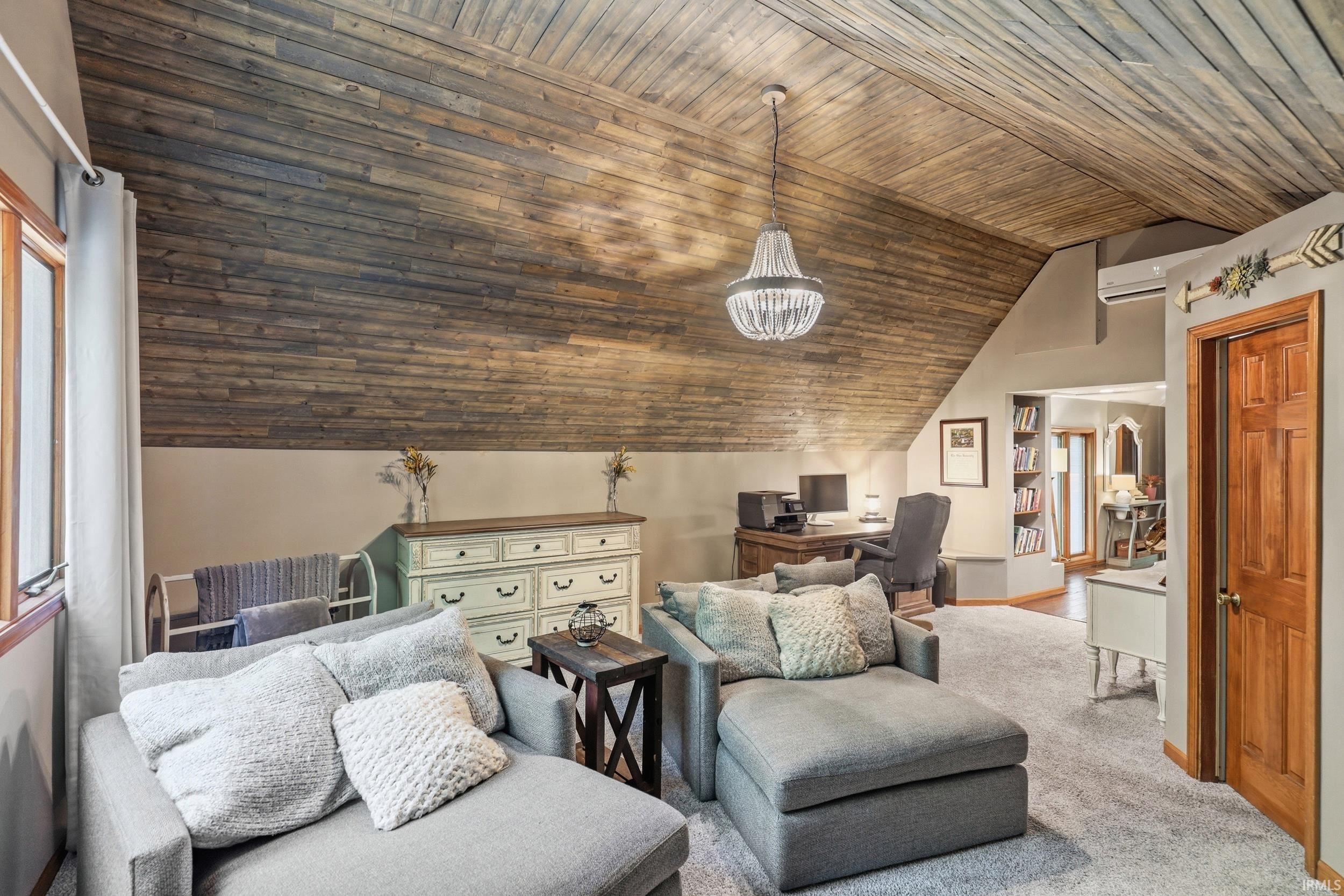 Vaulted wood-finish plank ceiling with a chandelier