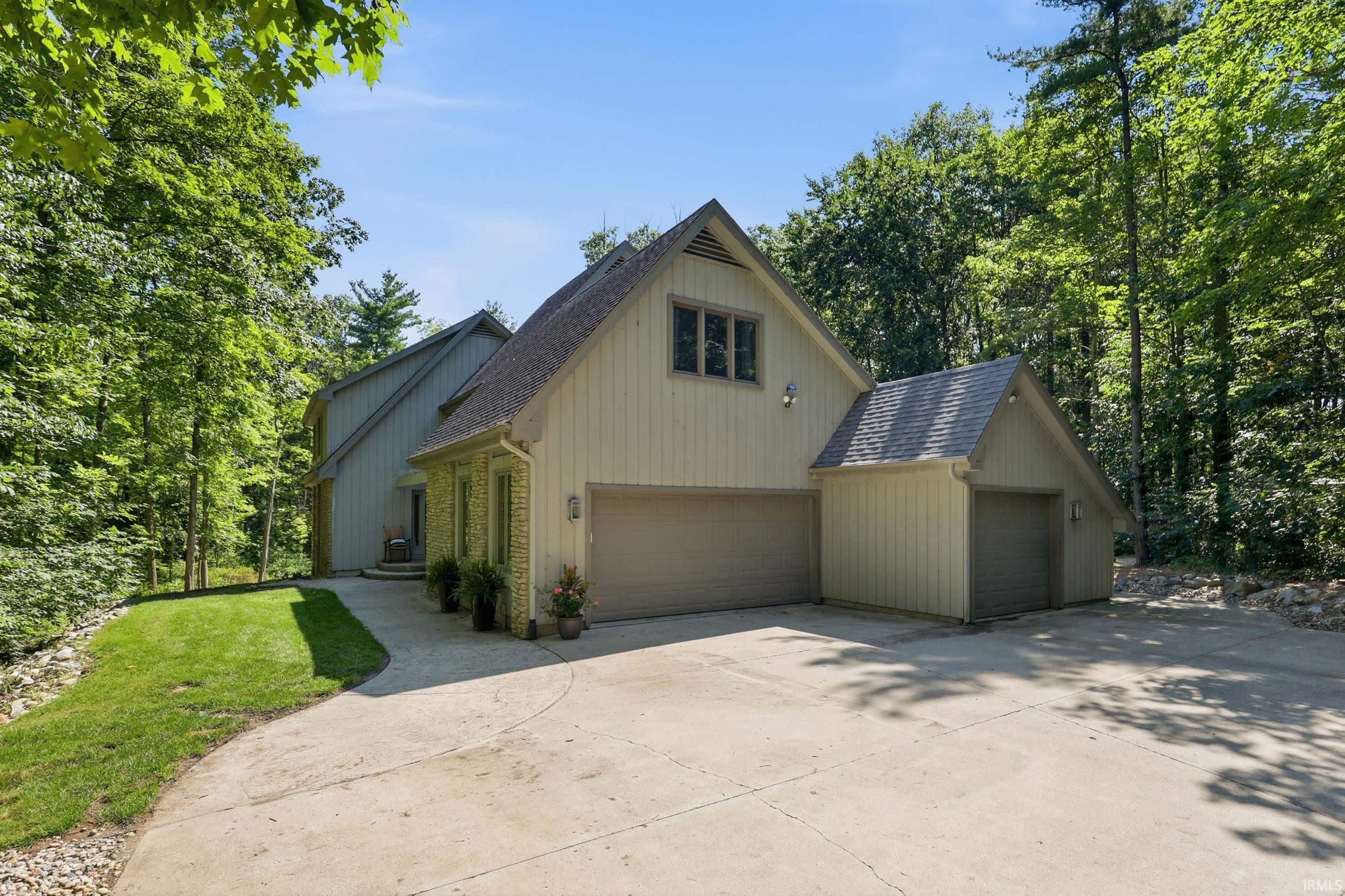Multi-level exterior with board and batten siding and brick accents