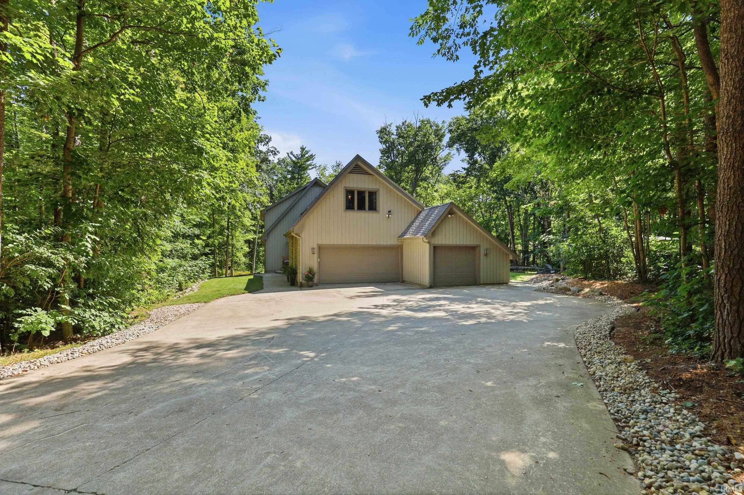 Expansive concrete driveway with gravel borders