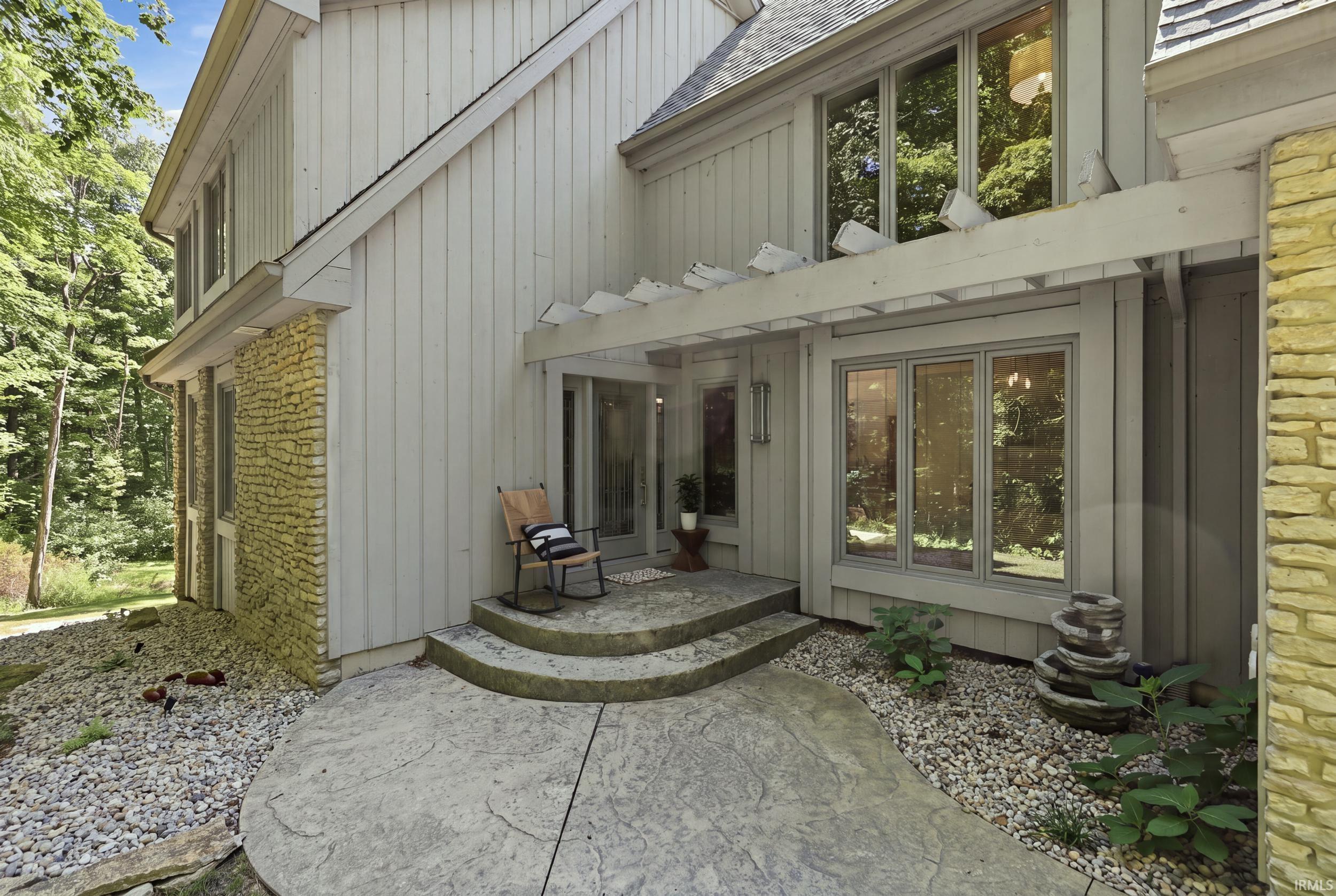 Exterior featuring vertical siding and stone accents