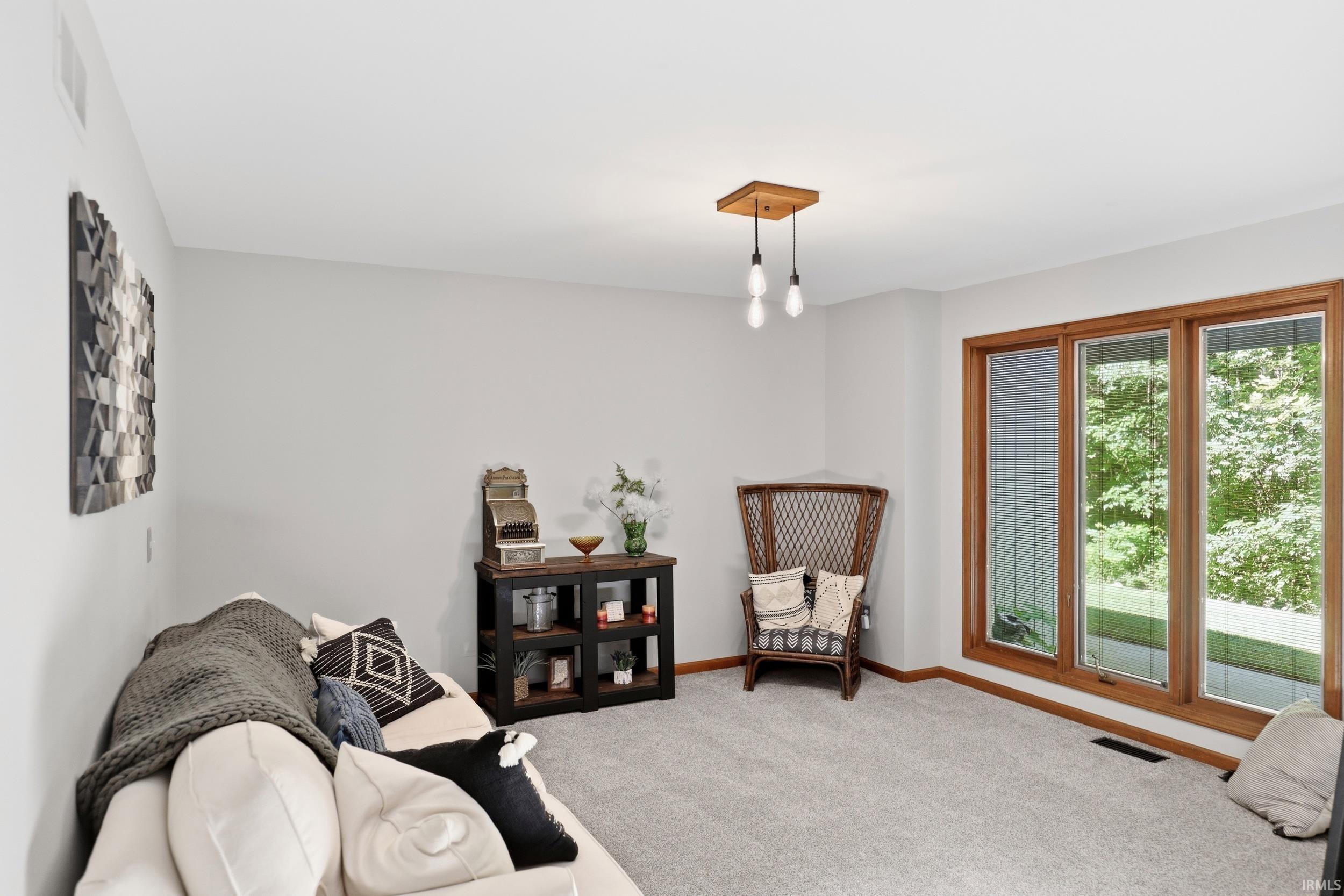 Light gray carpet flooring complements light gray wall paint