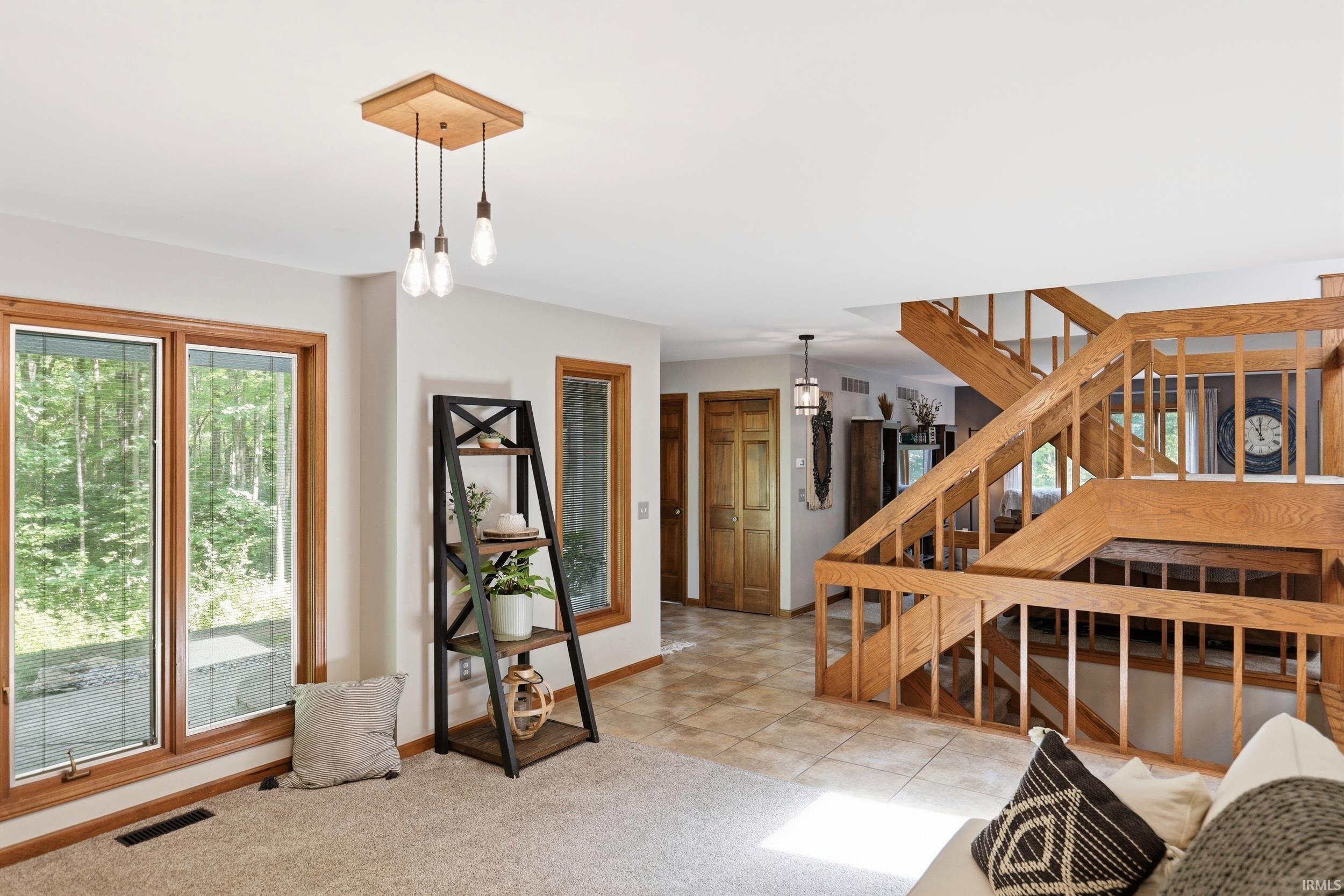 Grand staircase featuring wood railings and balusters