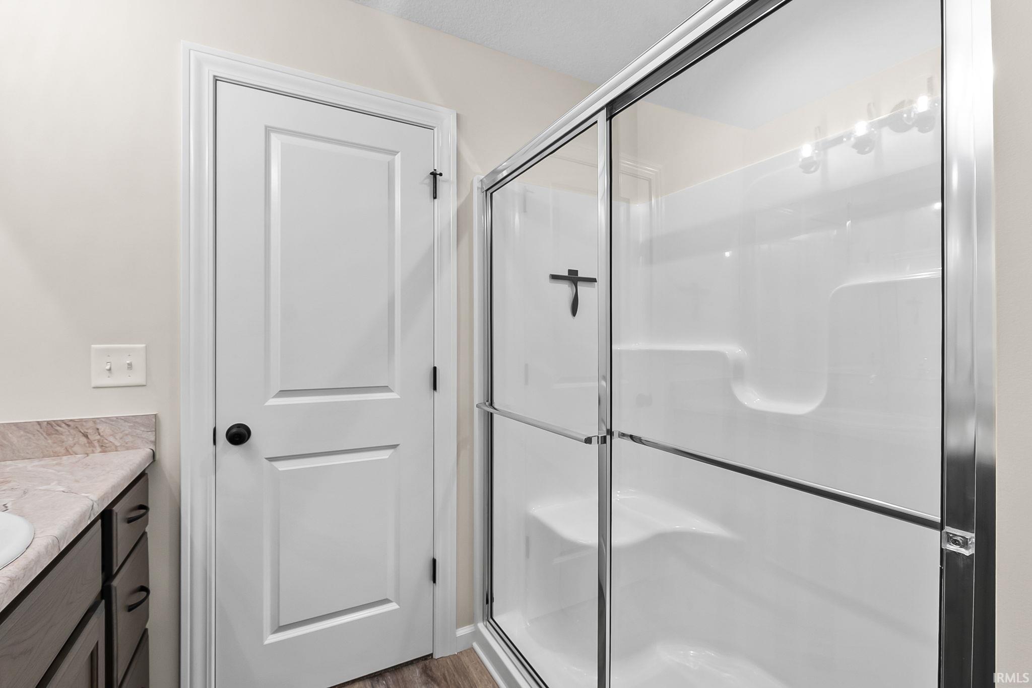 Fiberglass shower enclosure with sliding glass doors, integrated shelving, and a built-in seat
