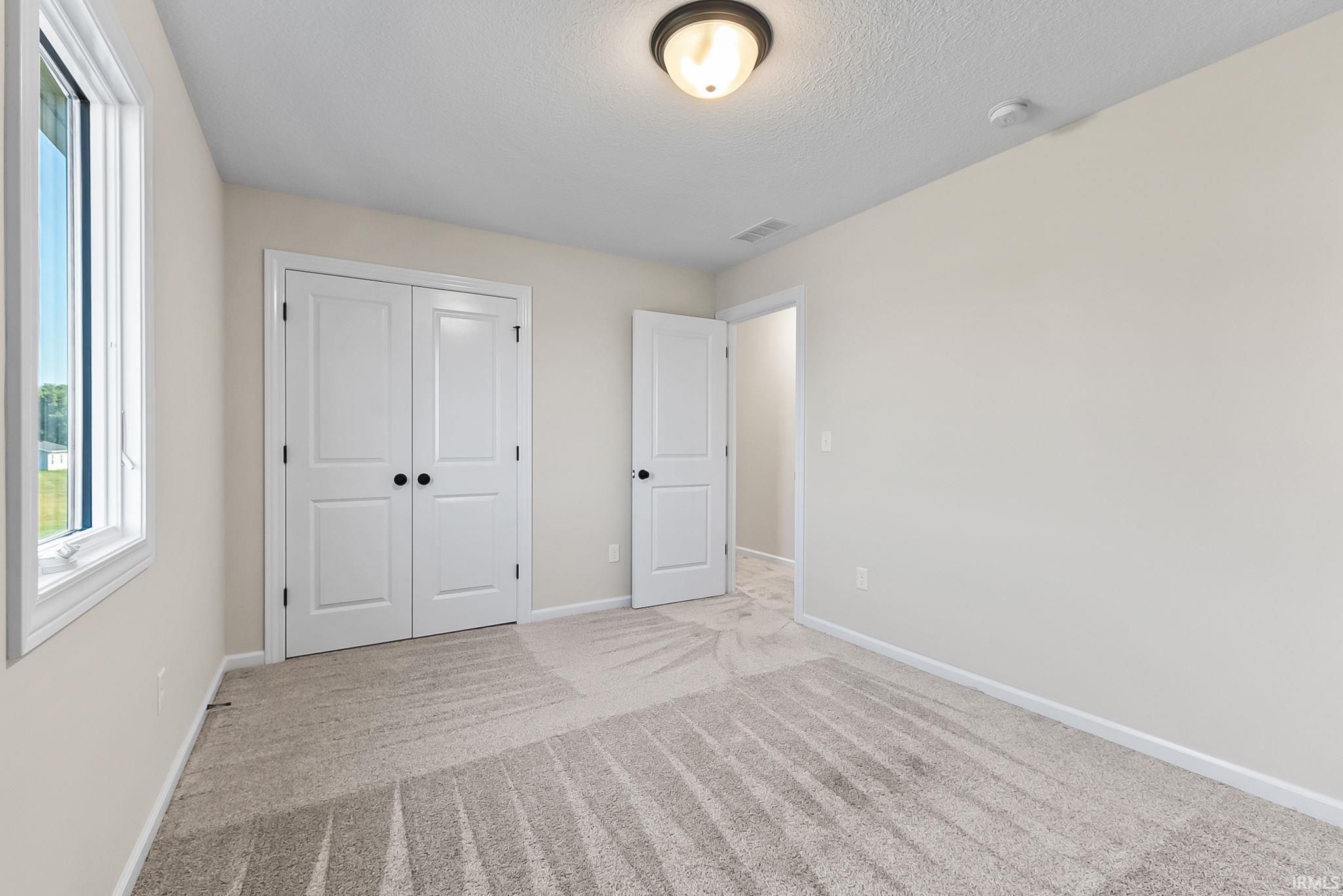 Neutral-toned carpeting throughout the room