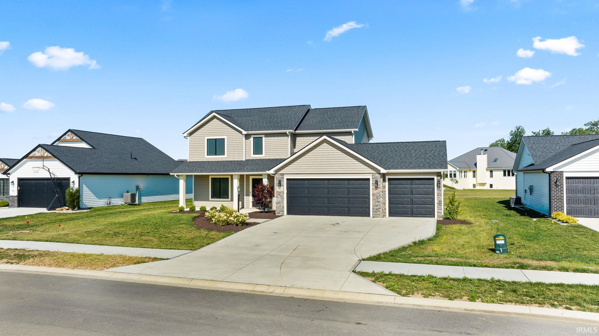 Contemporary two-story residence featuring light gray siding and dark gray roofing