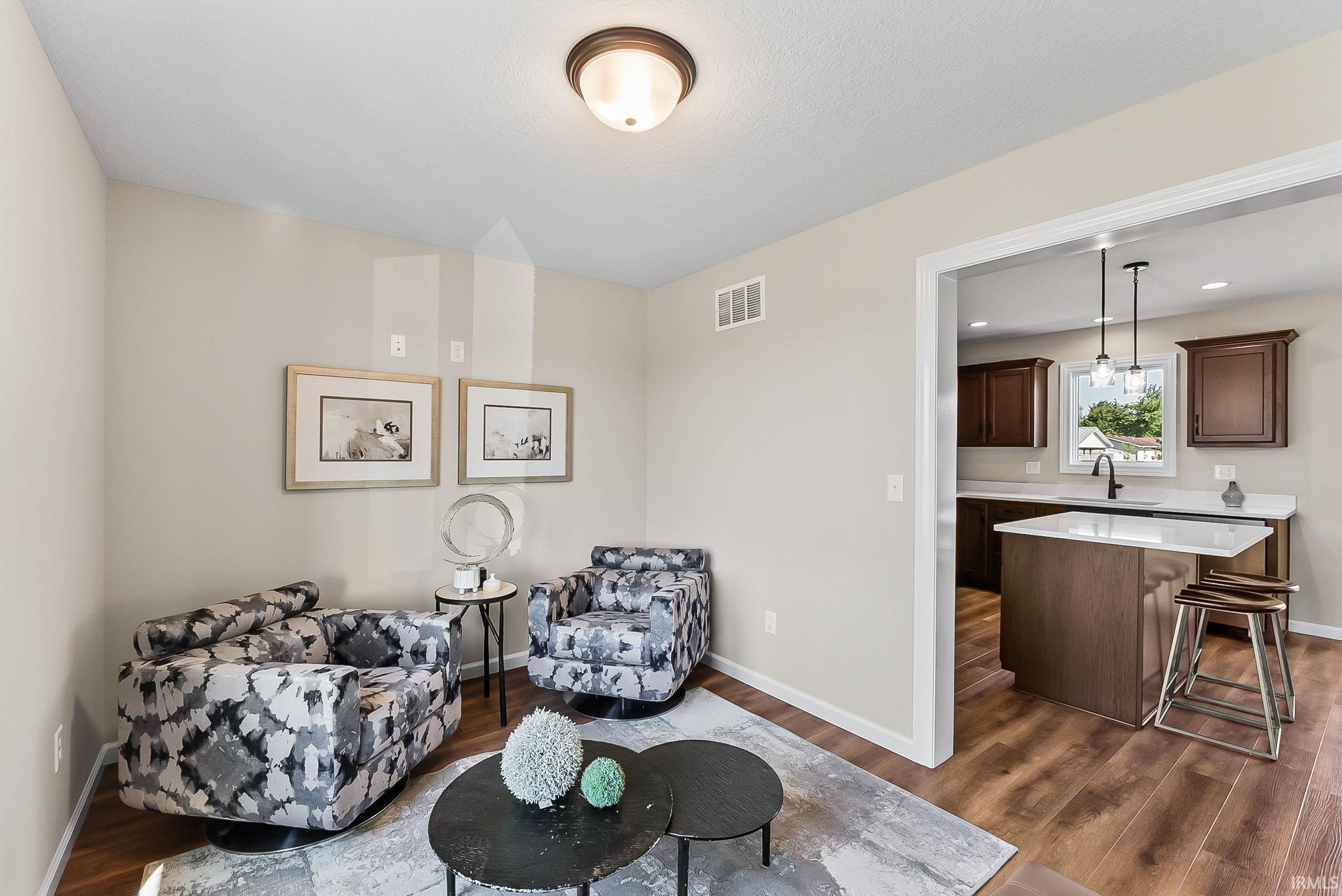 Open concept living space with wood-finish flooring