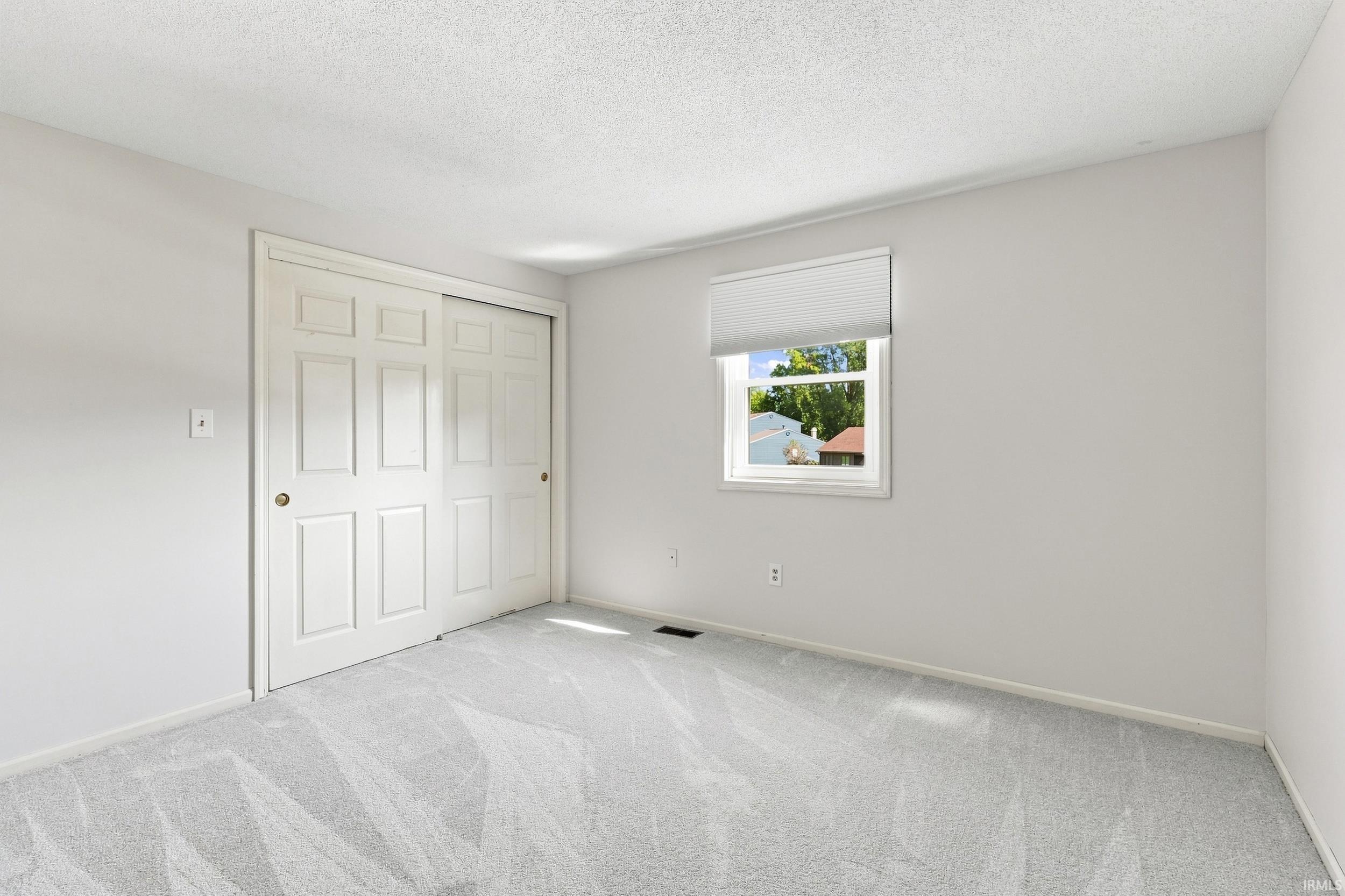 Neutral wall tones with light gray carpeting