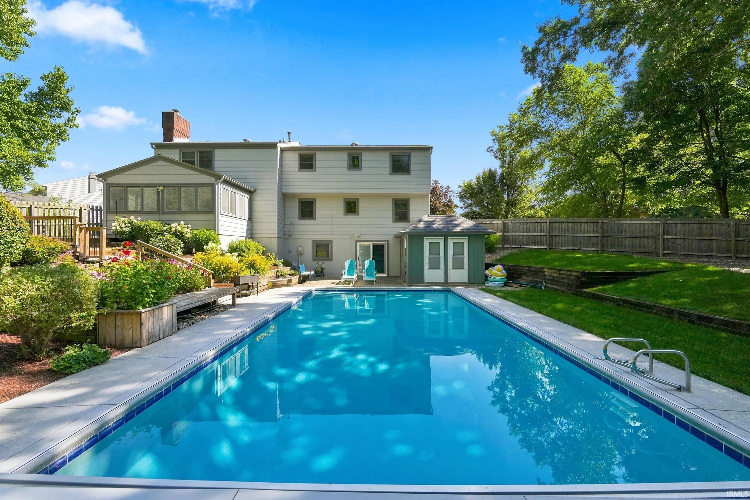 In-ground swimming pool with a concrete surround