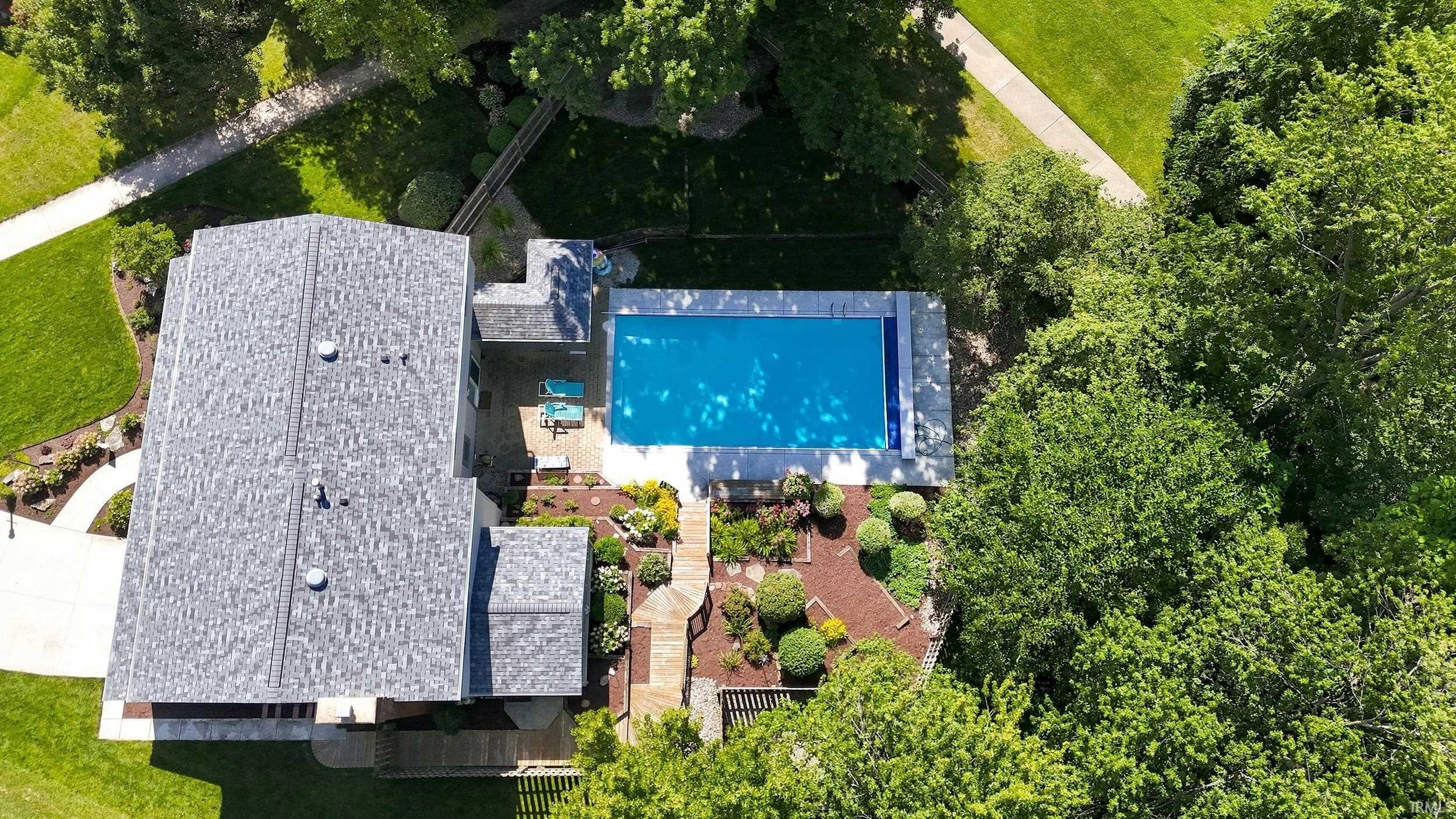 Expansive property featuring a shimmering in-ground swimming pool with surrounding patio