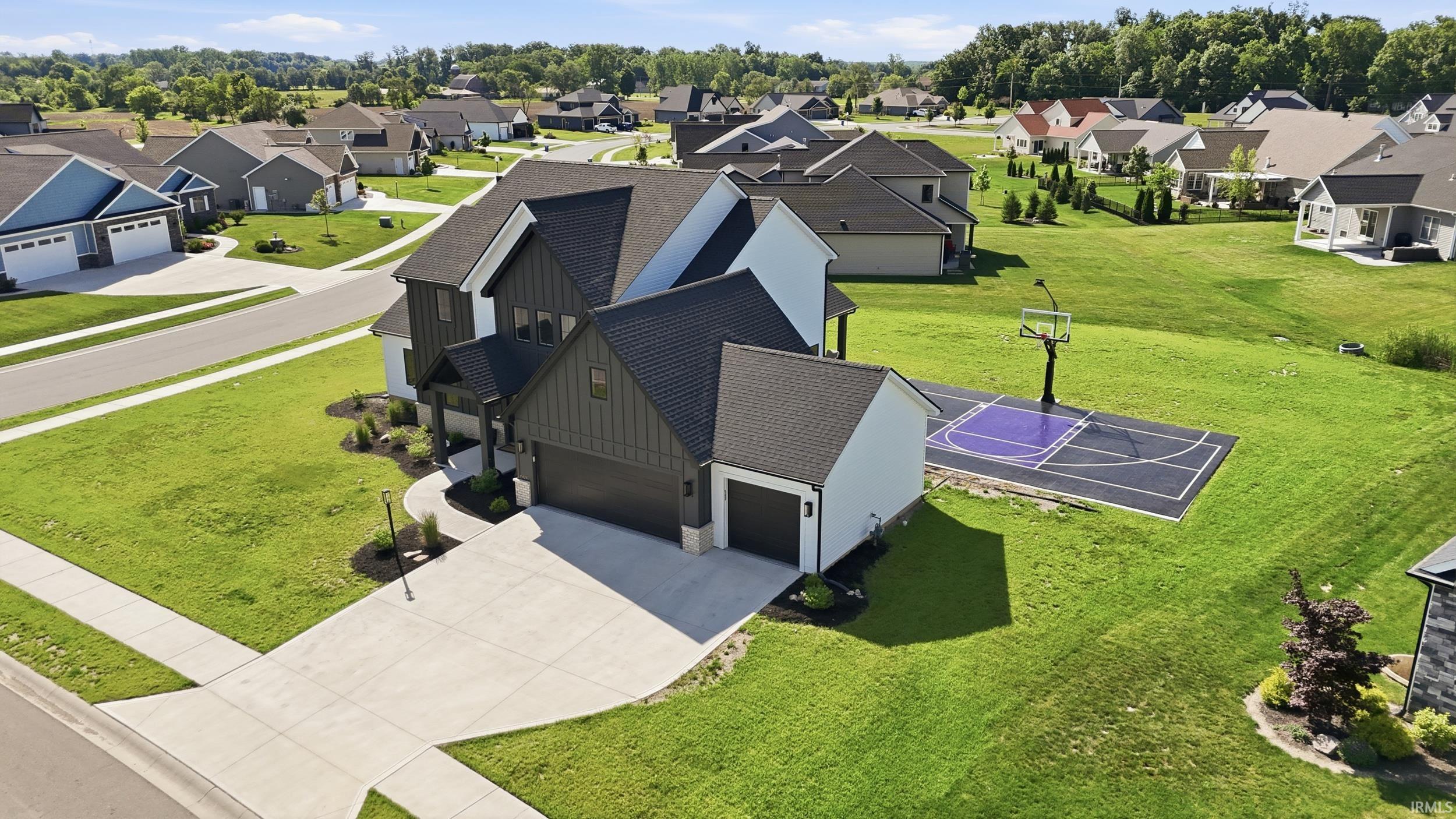 Contemporary residence featuring a striking dark facade with white accents and a two-car garage