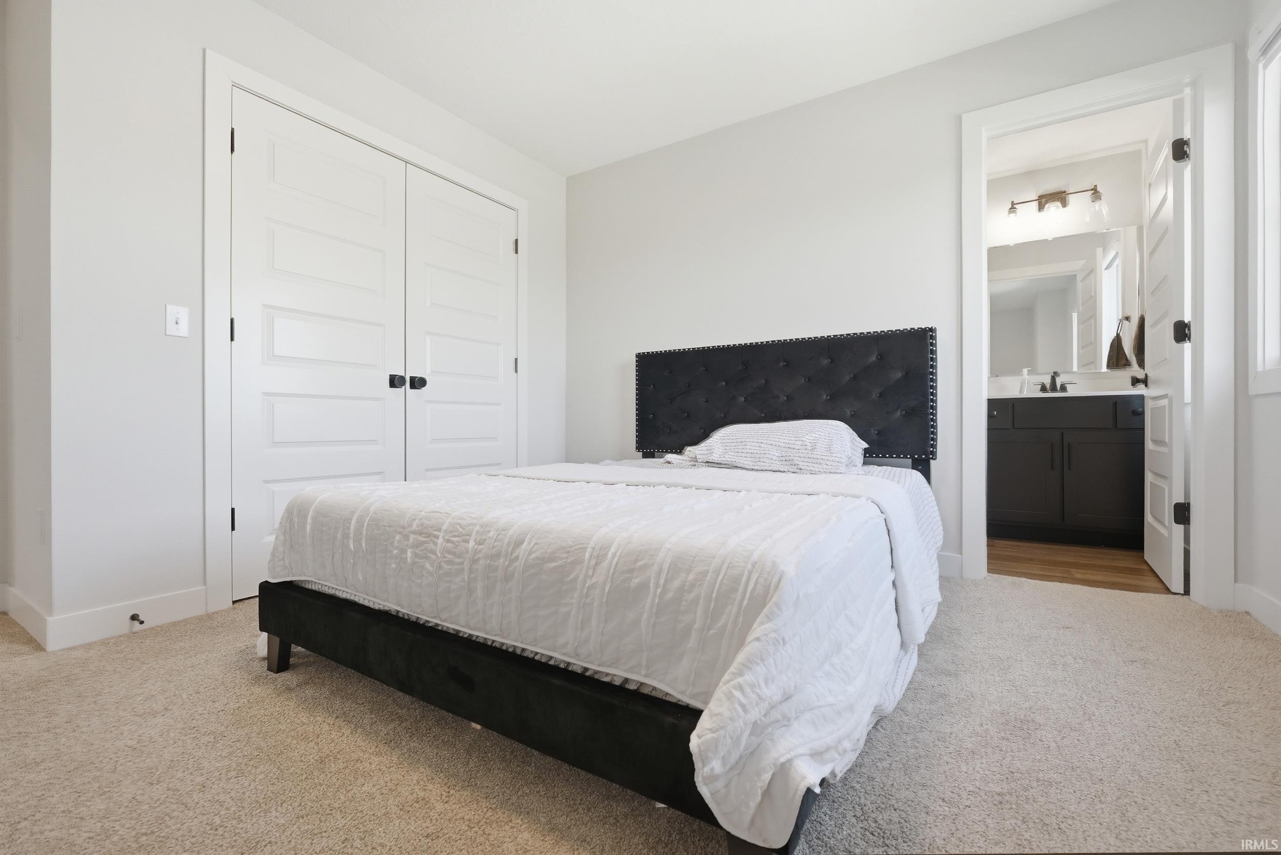 Carpeted interior room featuring white walls and white trim
