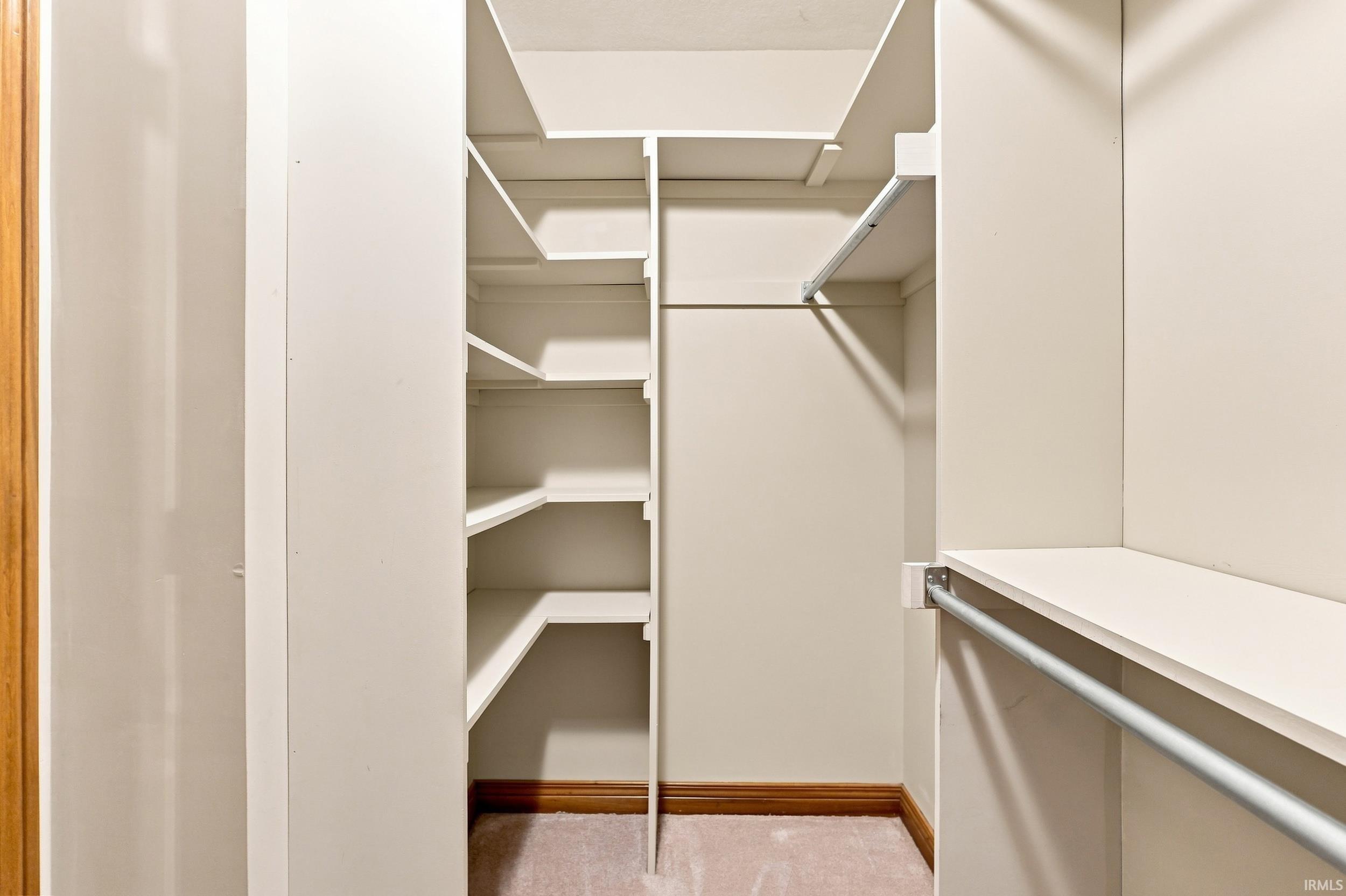 Built-in closet system featuring multiple shelving units and hanging rods for organized storage