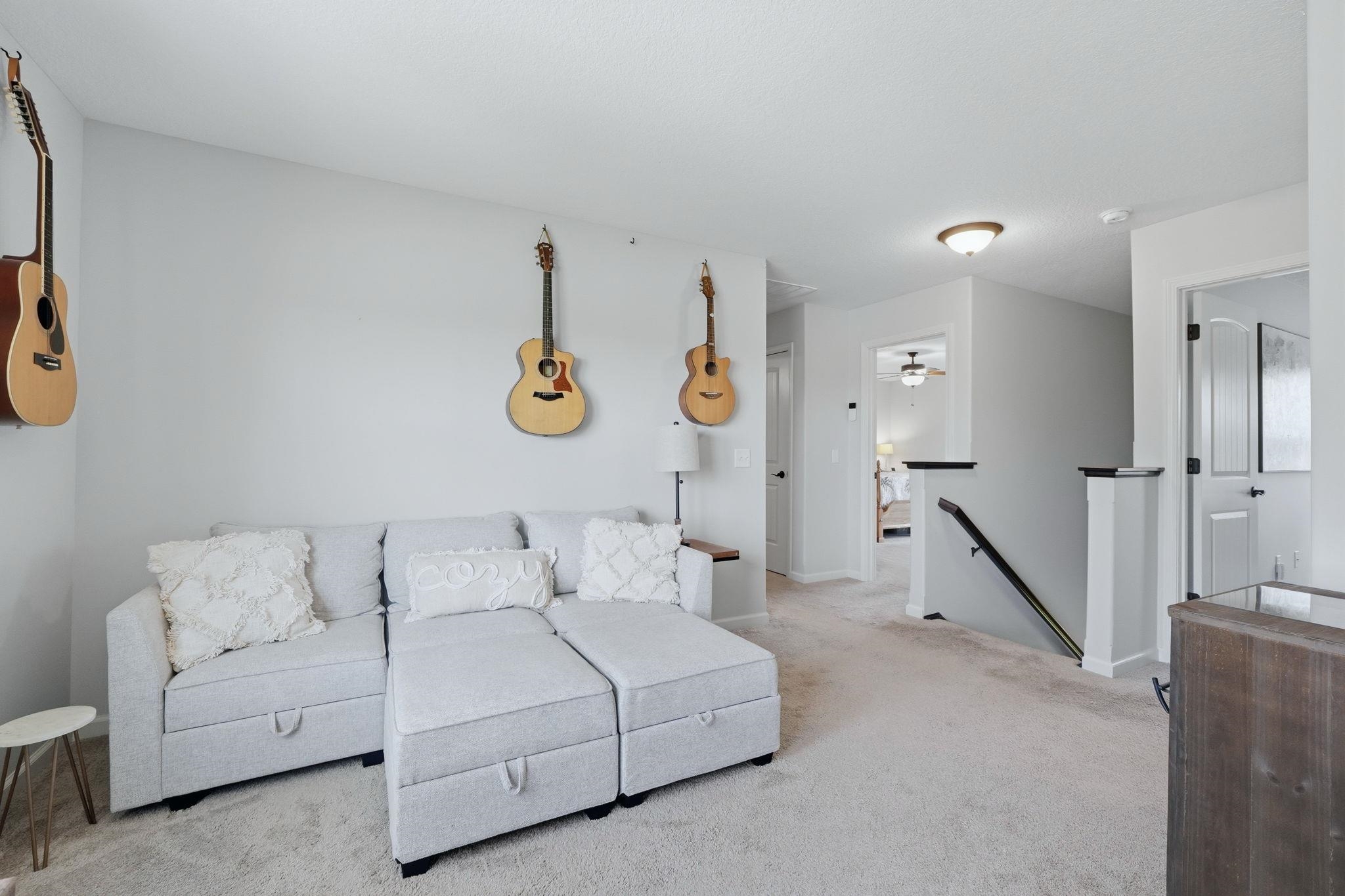 Carpeted living area featuring baseboards