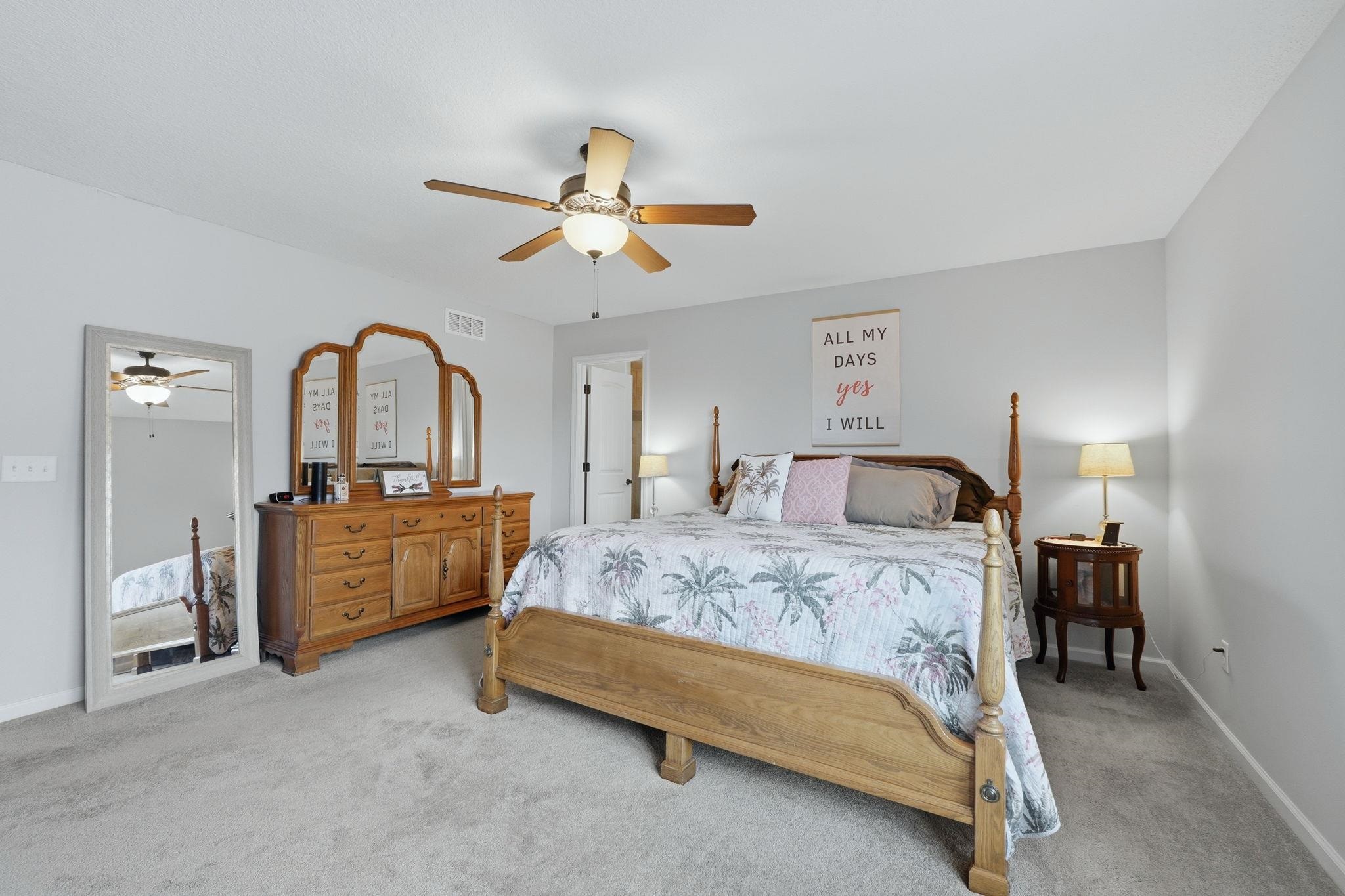 Bedroom featuring light colored carpet and ceiling fan