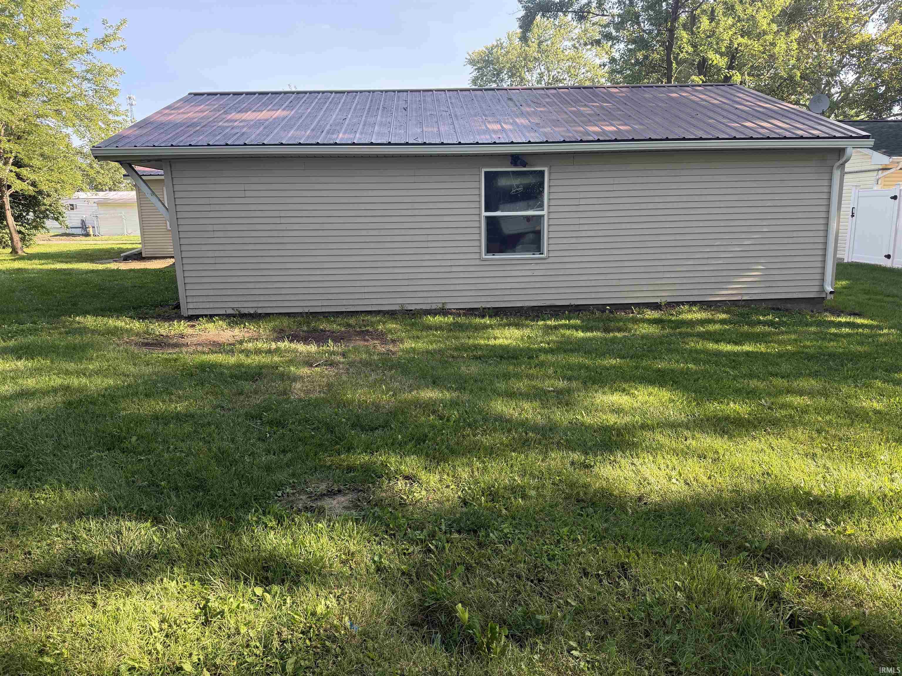Detached structure with horizontal siding and a metal roof