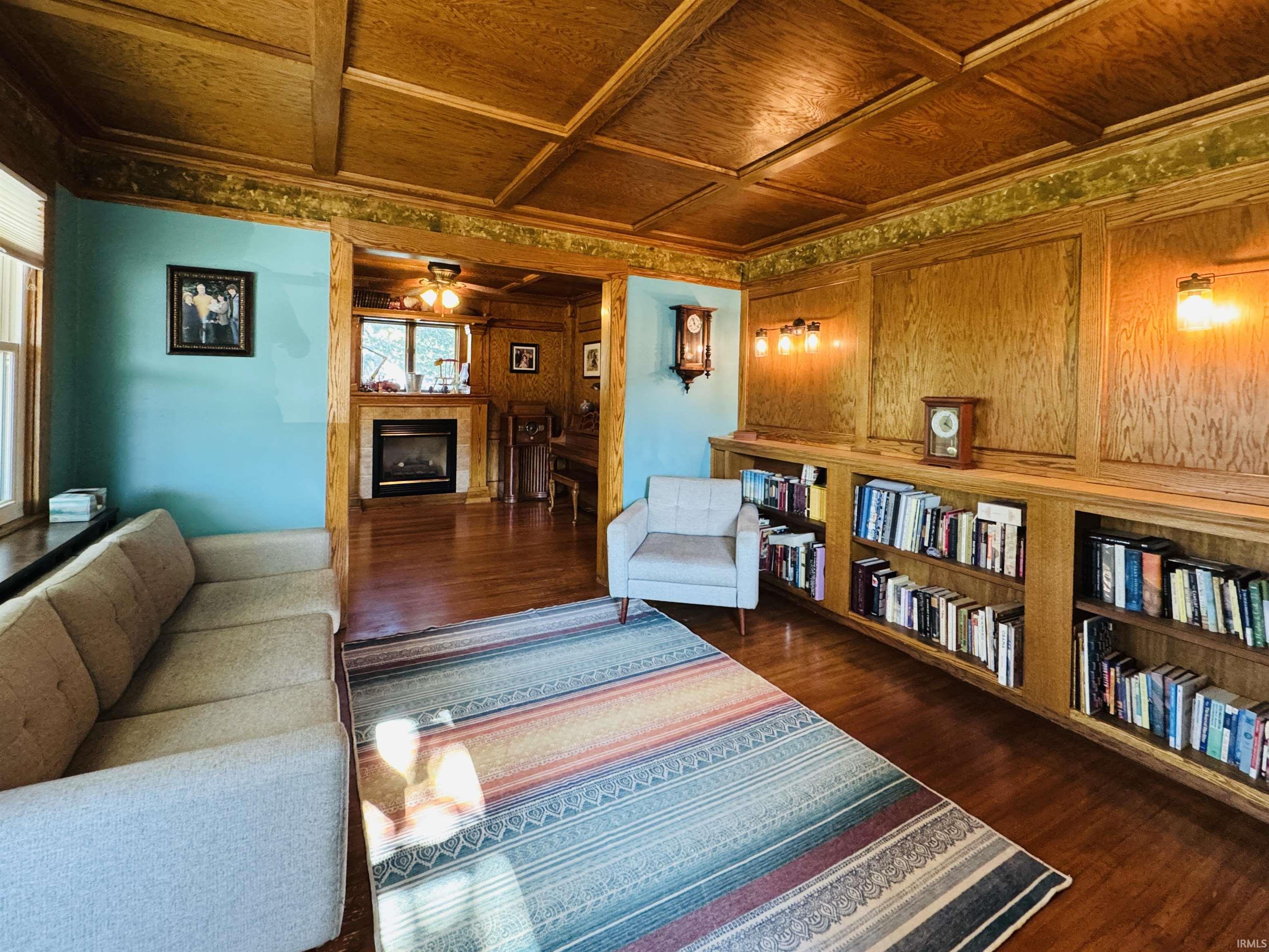 Wood-finish coffered ceiling complementing hardwood flooring and extensive wood paneling