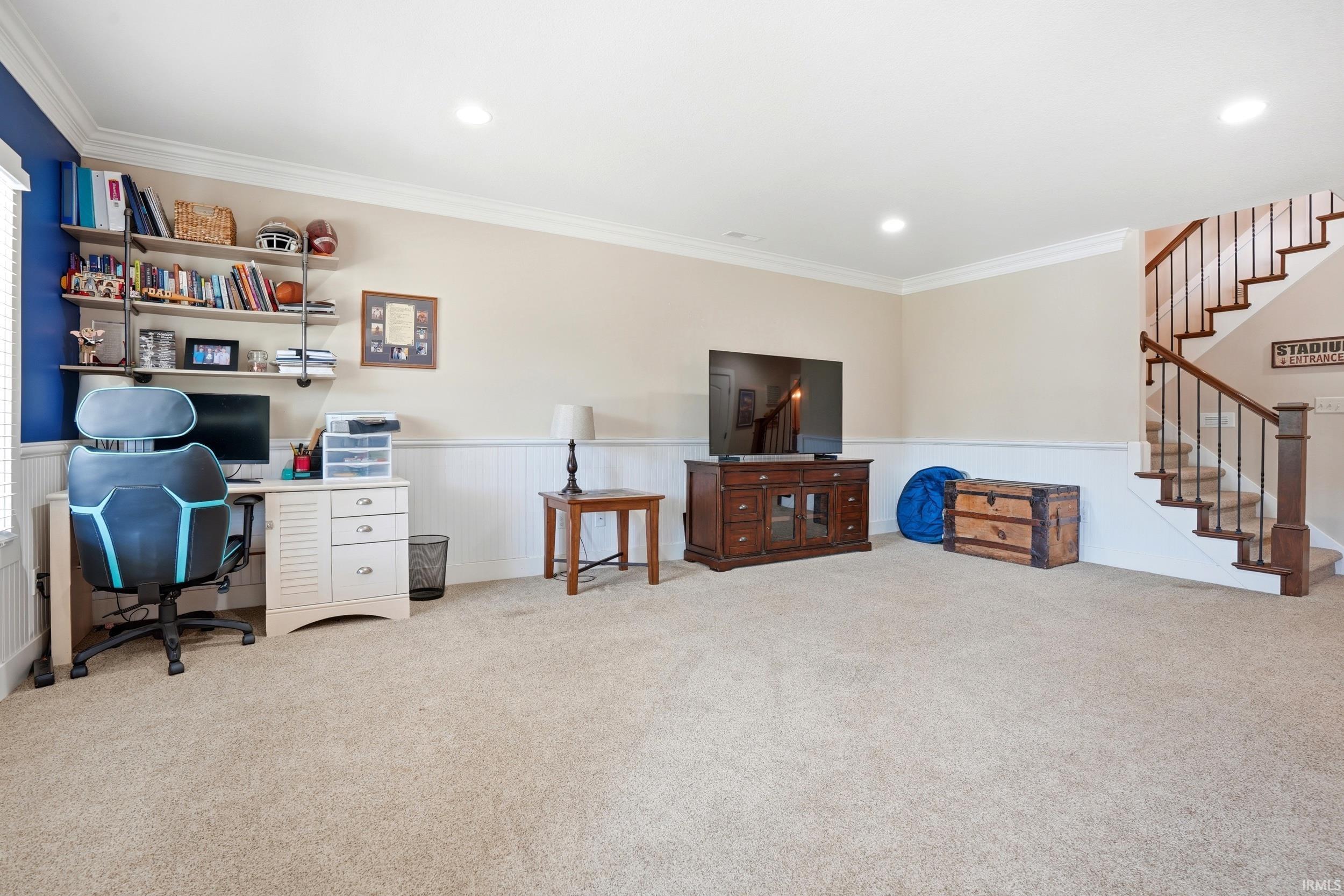 Expansive finished recreation room featuring neutral carpet flooring, recessed ceiling lighting, and abundant square footage