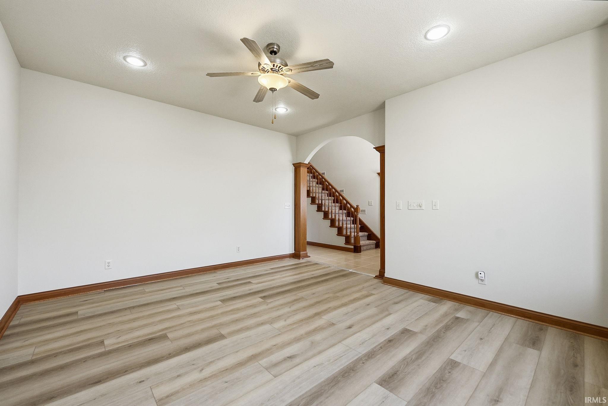 Spacious interior featuring wide plank wood-finish flooring and white walls