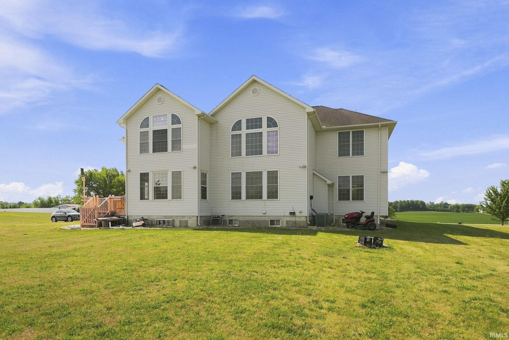 Two-story residence with white siding and a brown shingle roof