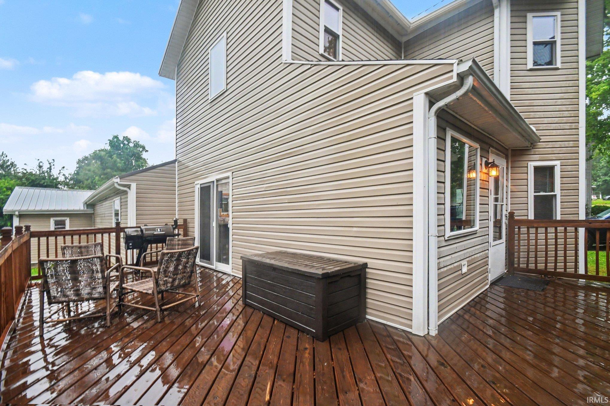 Expansive stained wood deck featuring a railing system