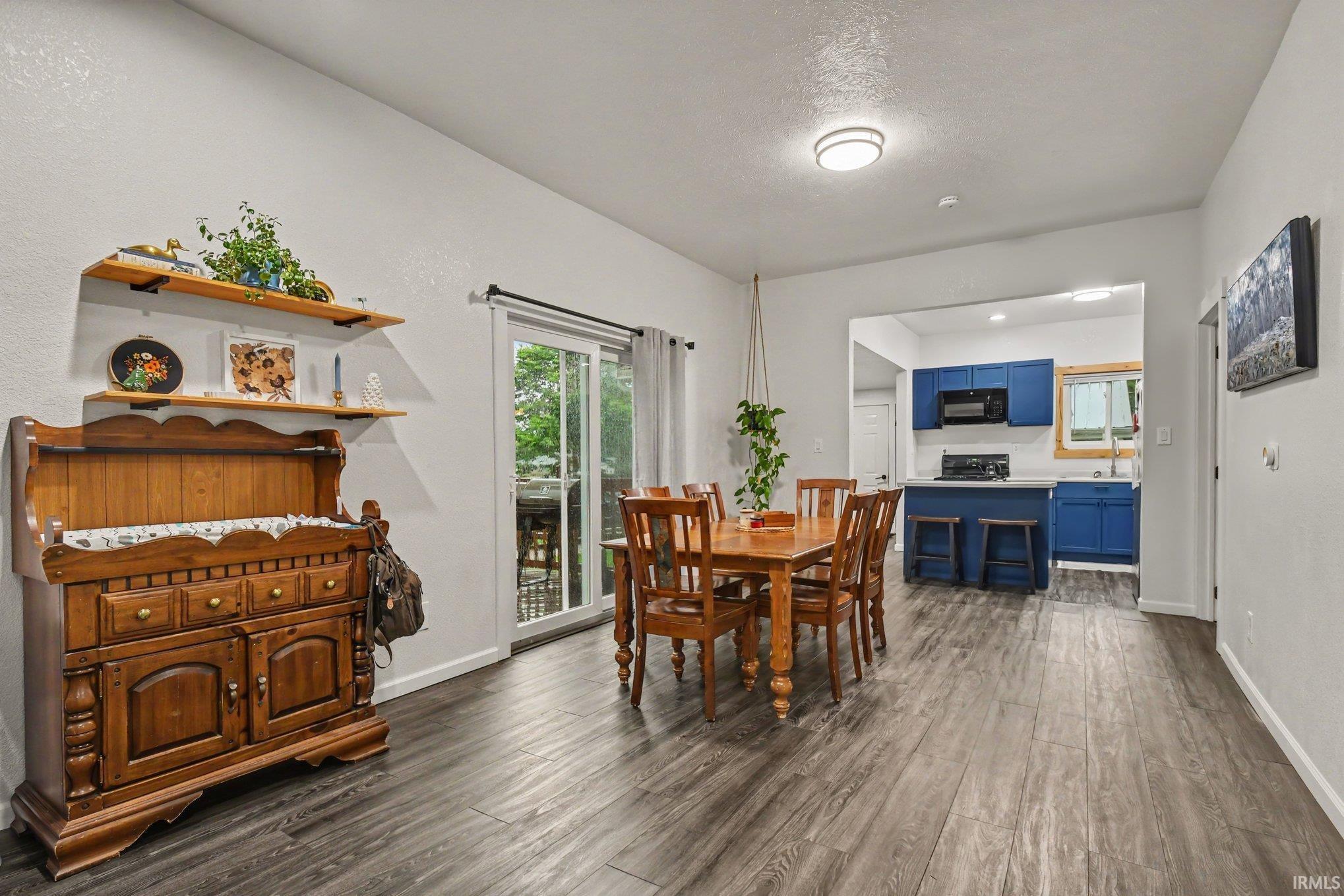 Dining area featuring wood-finish flooring and a sliding glass door