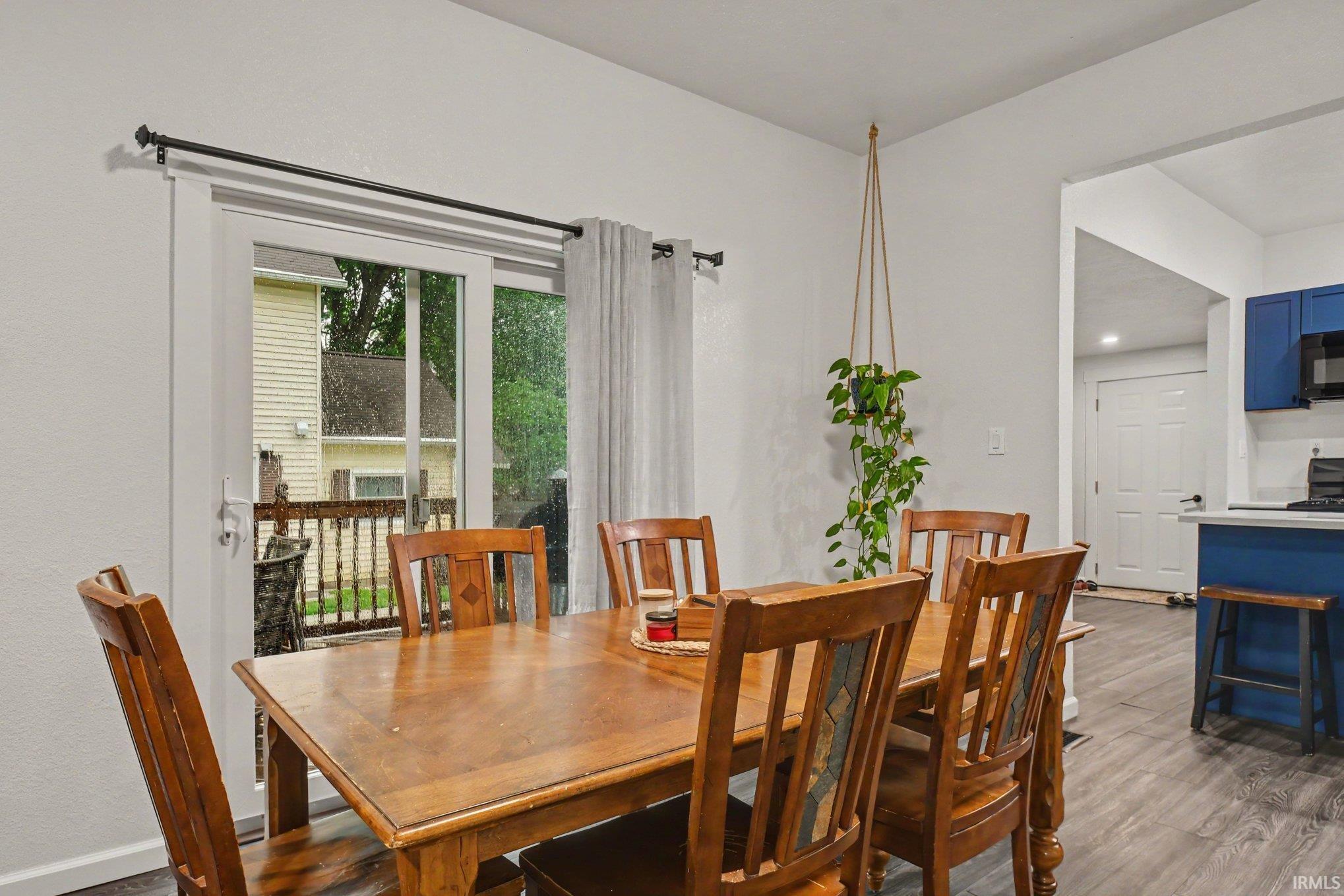 Dining area with wood-finish flooring and direct access to an outdoor deck