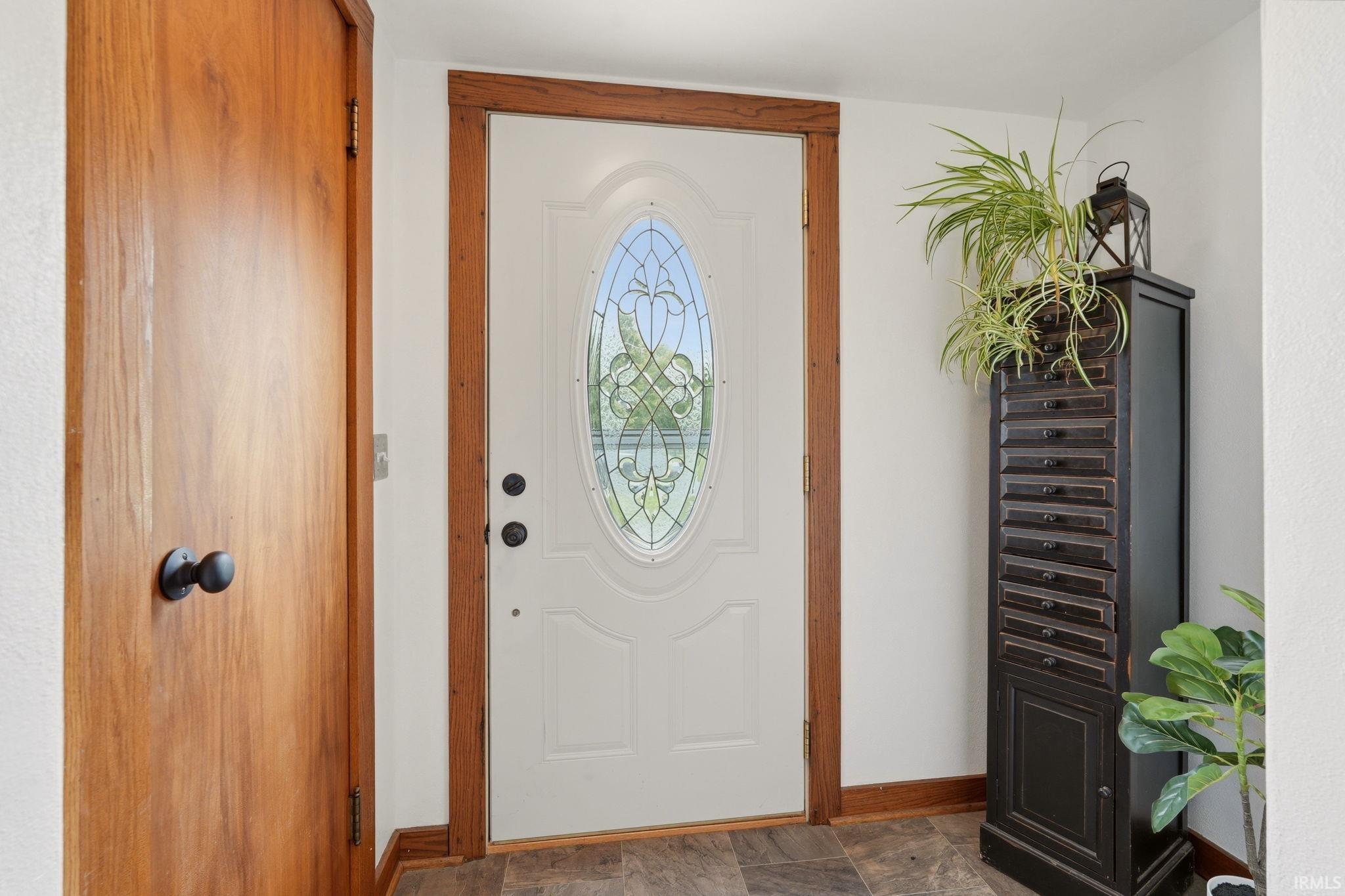 Entry door with decorative oval glass insert