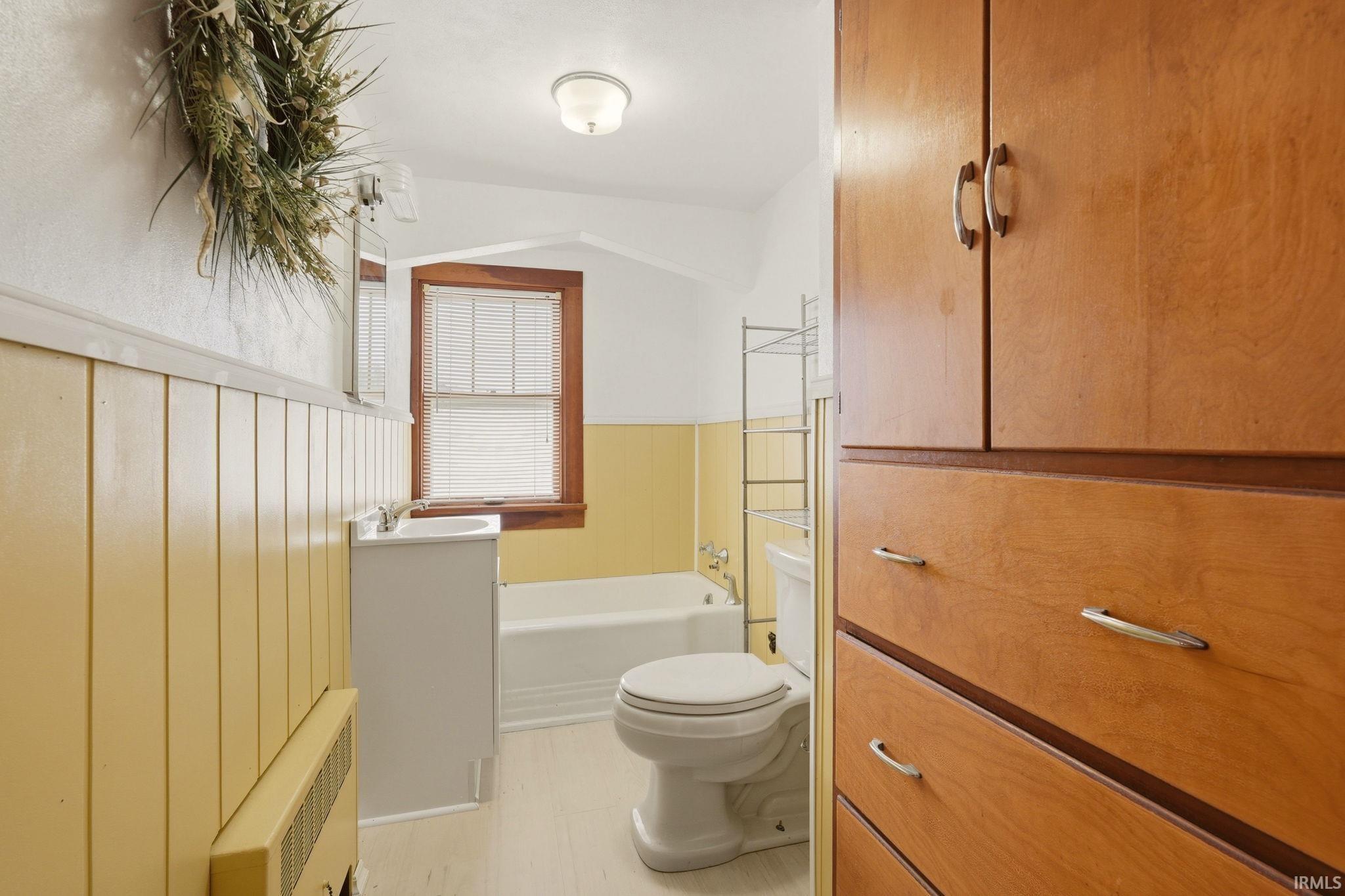 Warm wood-finish cabinetry providing extensive storage