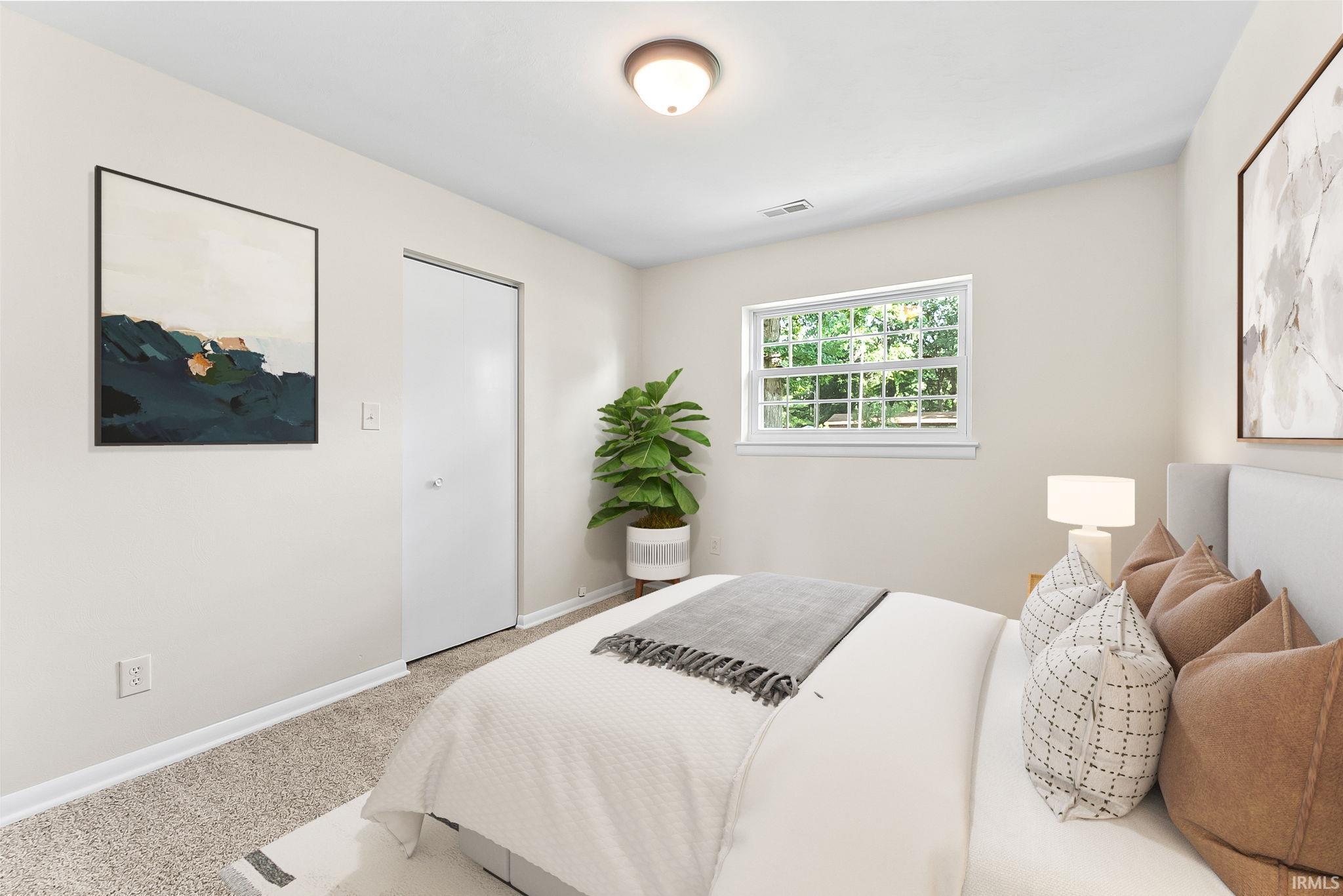 Neutral wall finishes, textured carpeting, a single window, and a flush-mount ceiling light