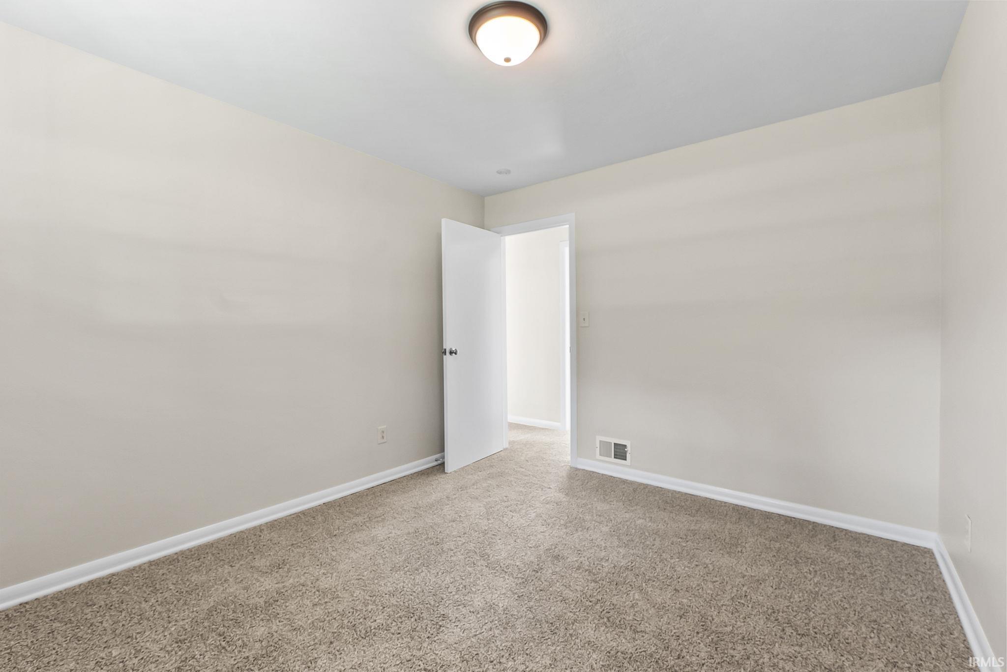 Neutral tone wall paint with a textured carpeted floor