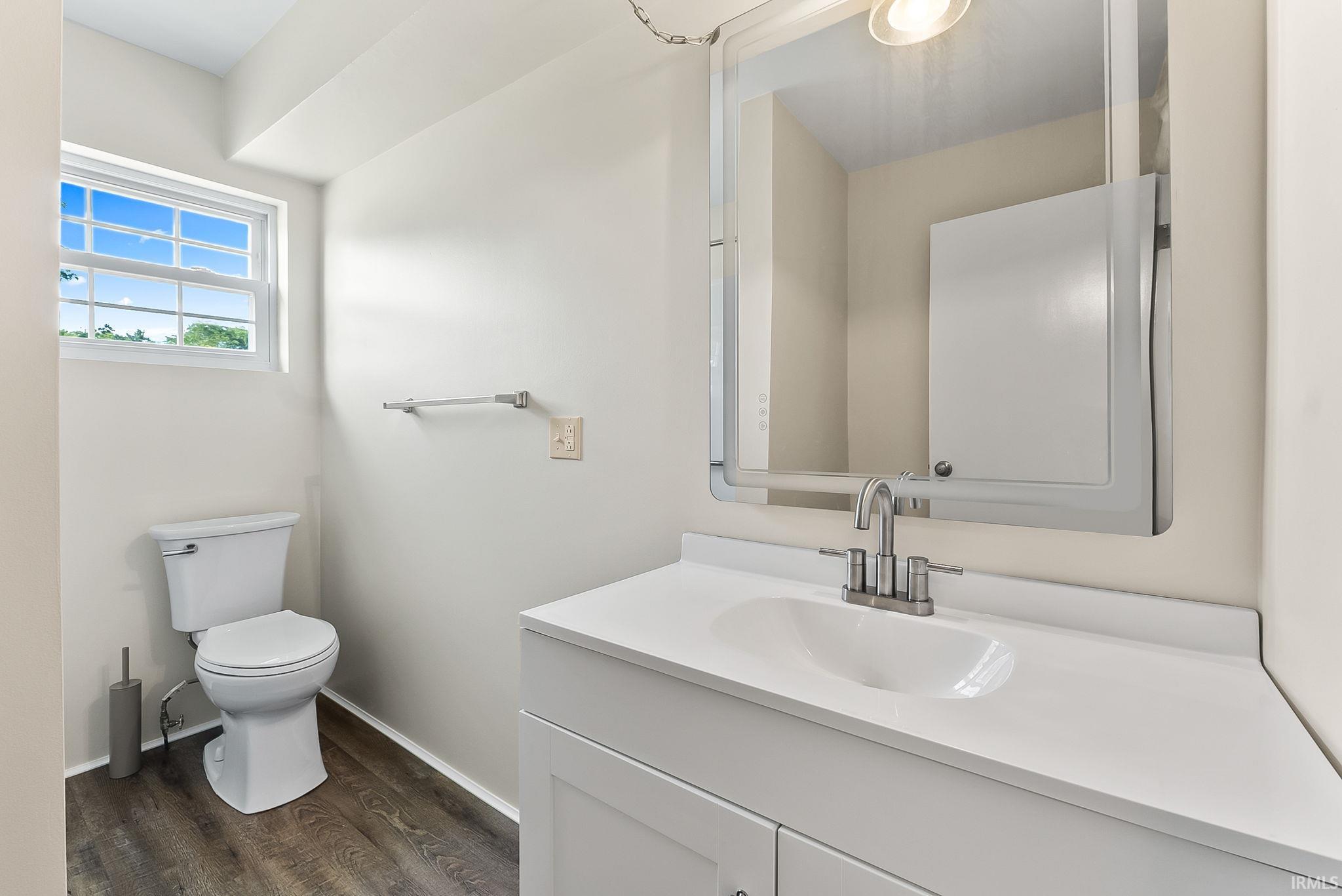 Modern bathroom featuring a sleek vanity with an integrated rectangular sink, white quartz countertop, and contemporary chrome faucet