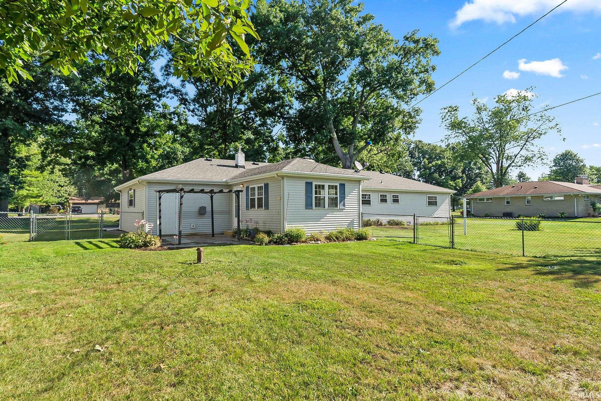 Charming single-story residence featuring a covered carport, updated siding, and multiple windows providing natural light