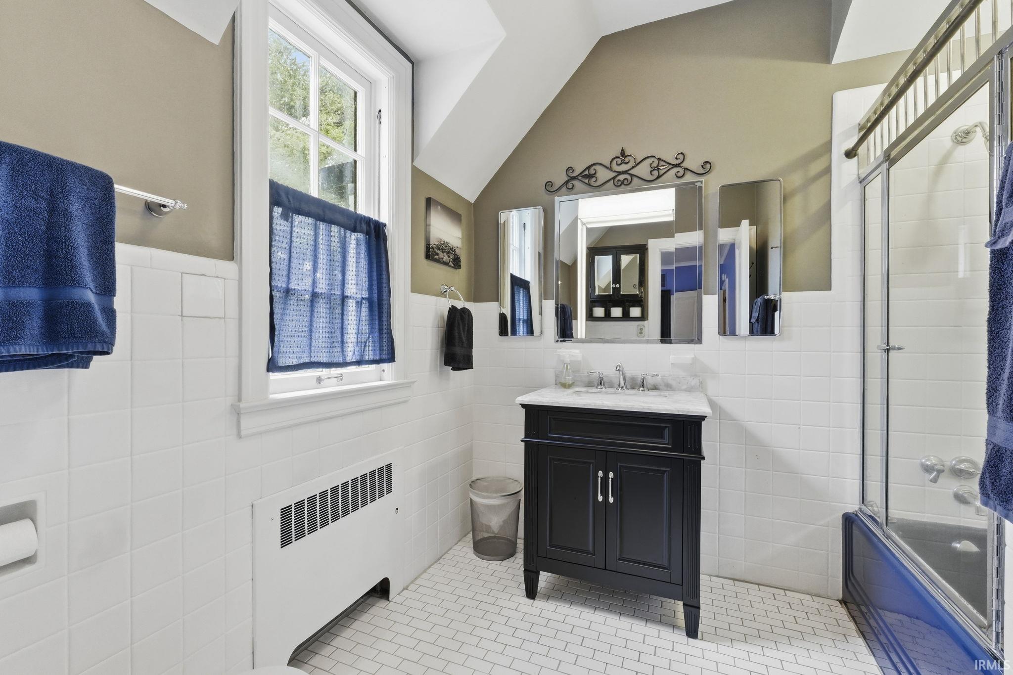 White subway tile walls with a contrasting dark vanity